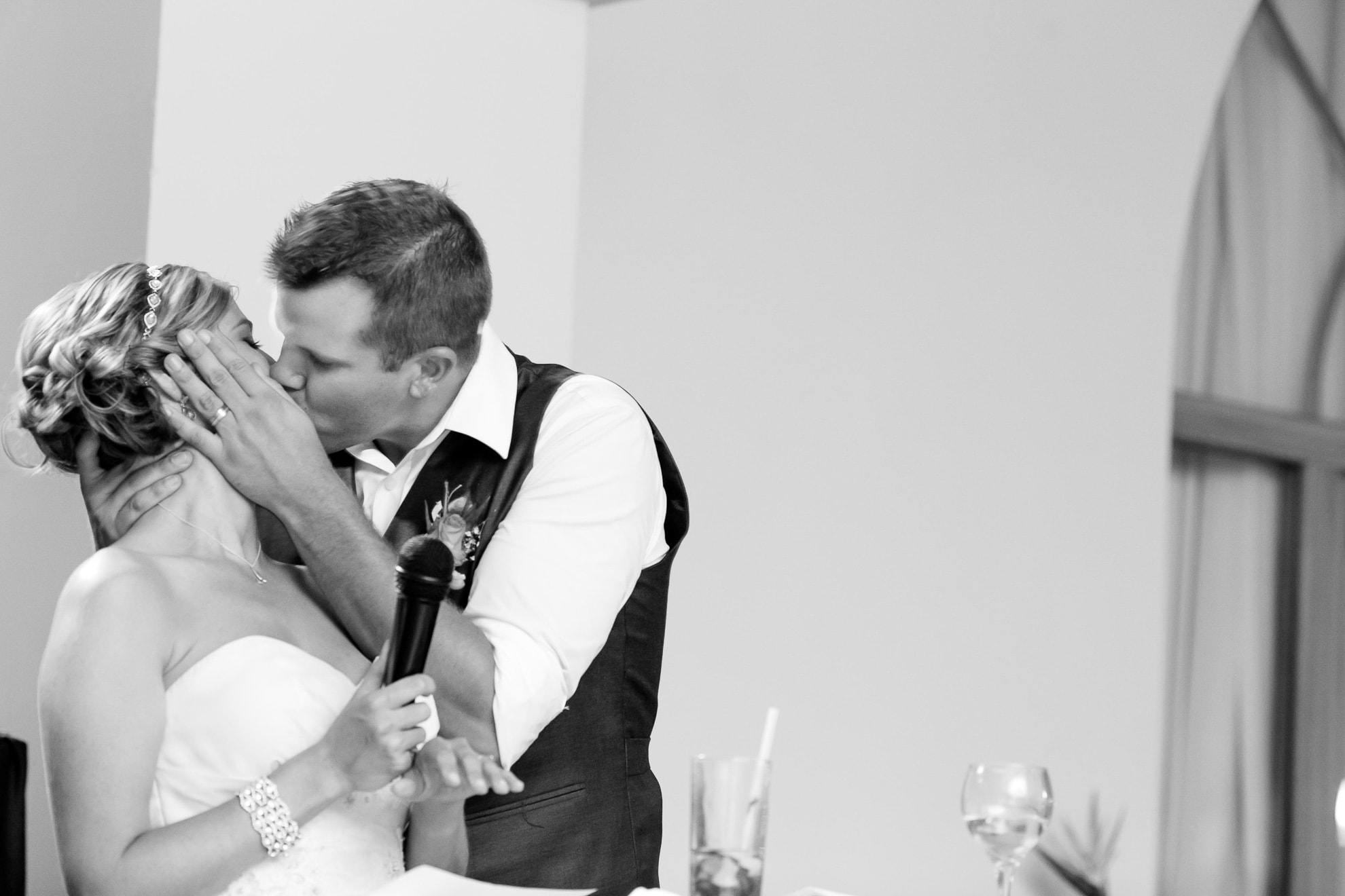 Groom kisses wife during wedding speeches