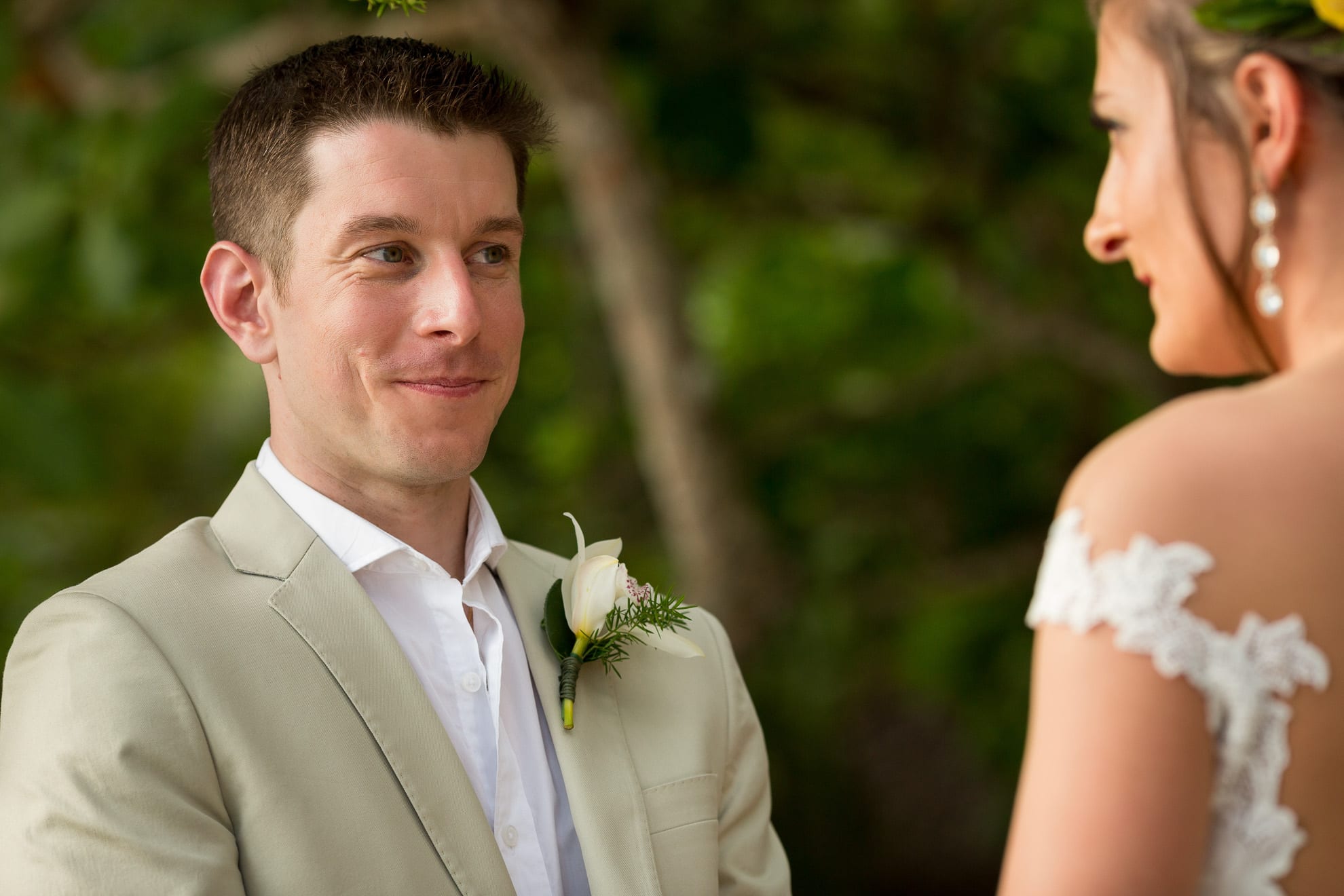 groom looking into bride's eyes during their vows