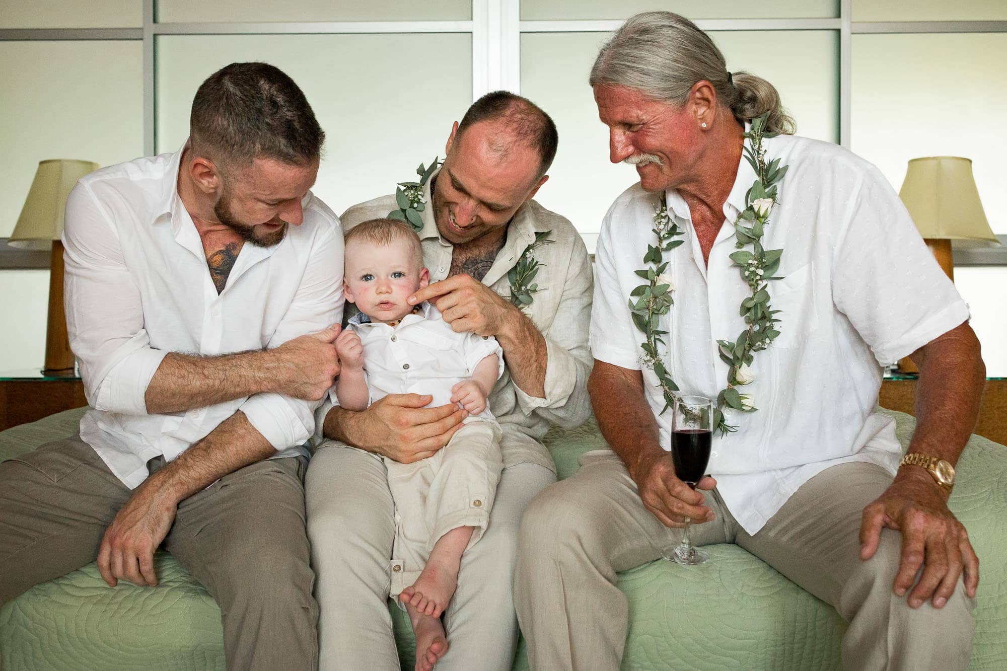 Groomsmen playing with the baby