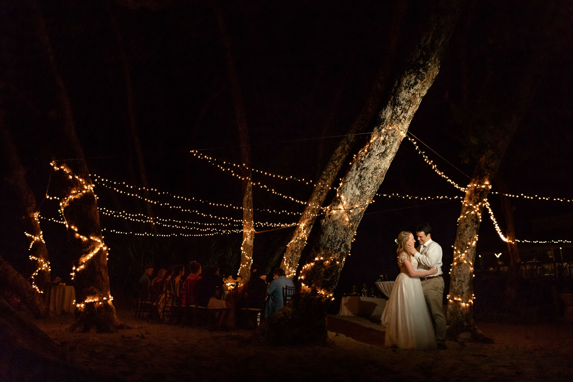 Creative wedding photography: spotlight on the couple surrounded by fairy lights