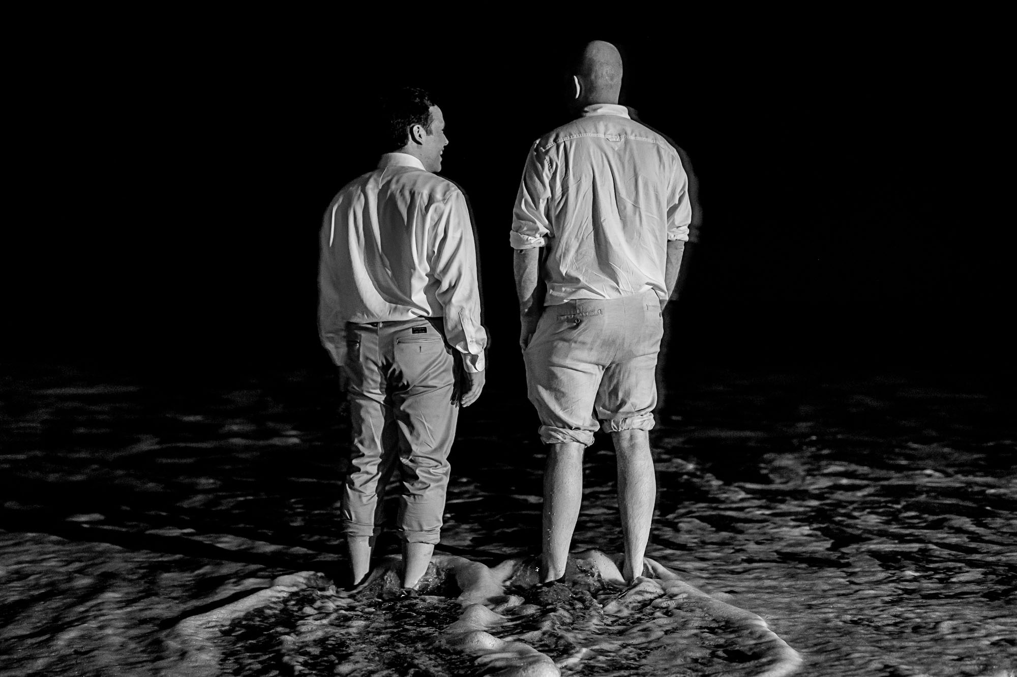 The groom and his friend enjoying a moment in the ocean