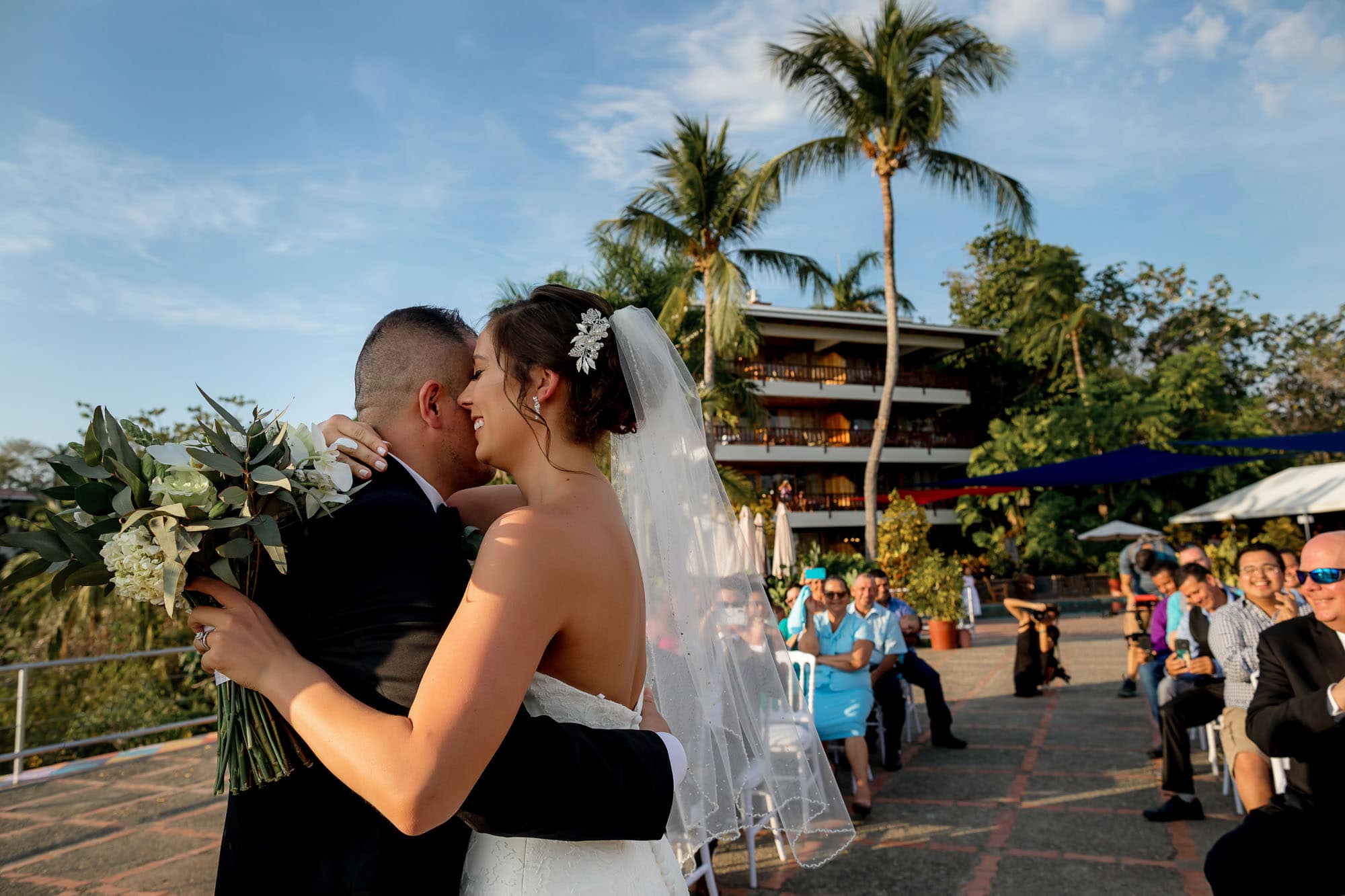 The bride and groom share a hug on the helipad at Costa Verde