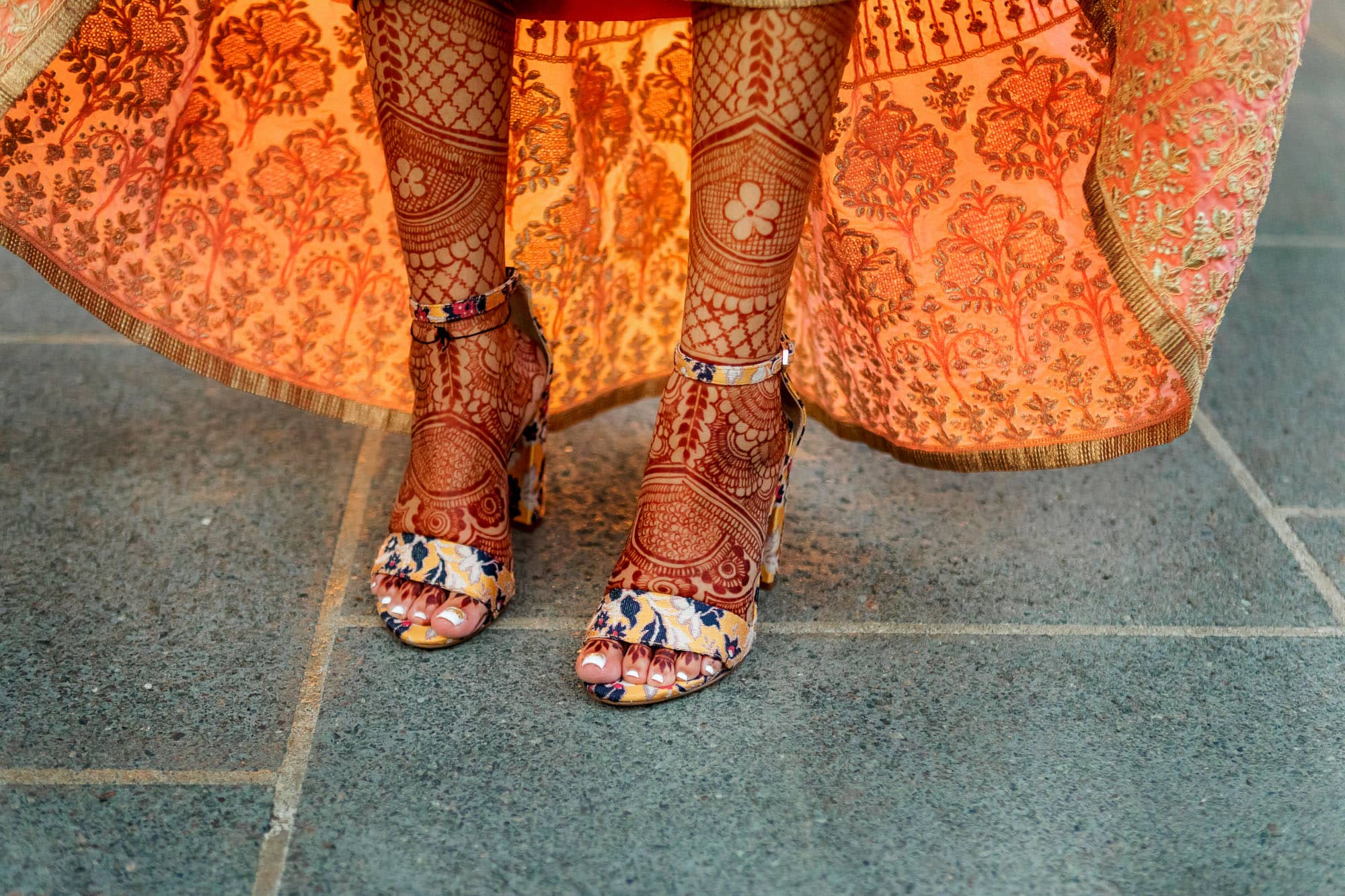 The bride showing off the wedding henna on her legs