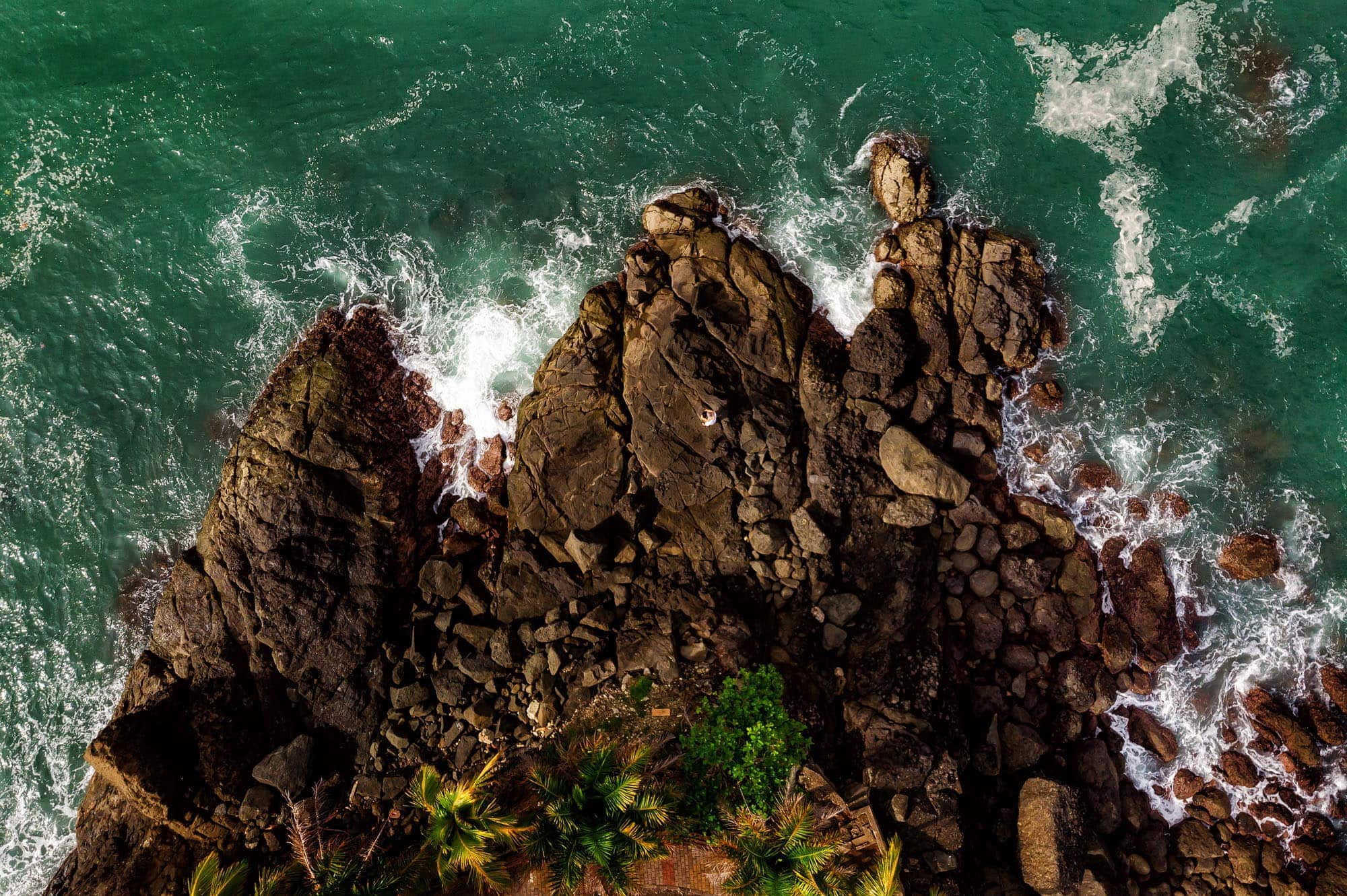 Overhead shot of the bride and groom on the rocks at Nahomi