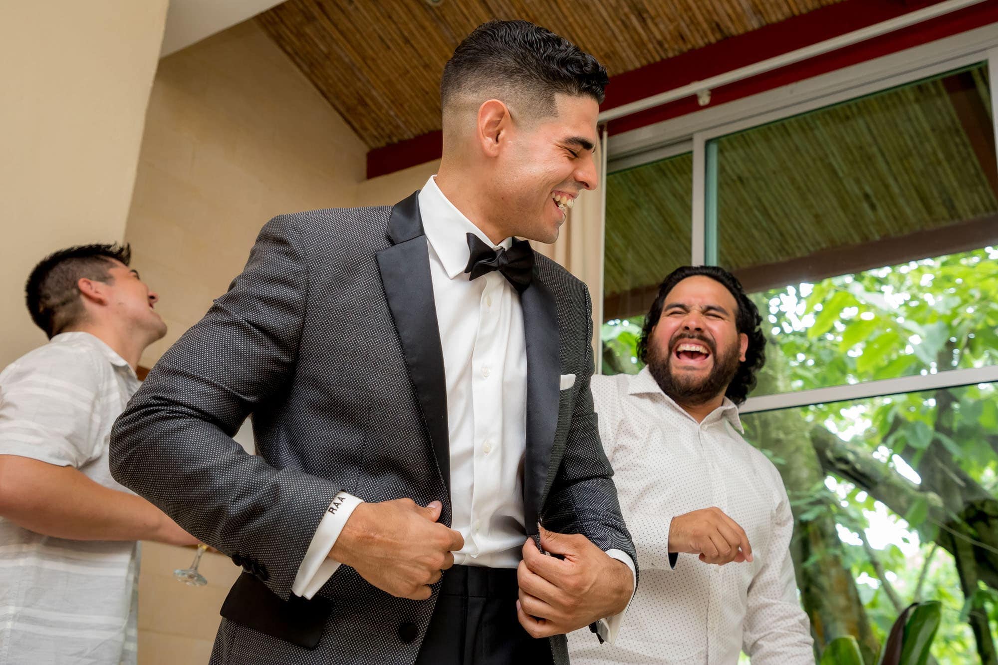 The groom laughing with a friend