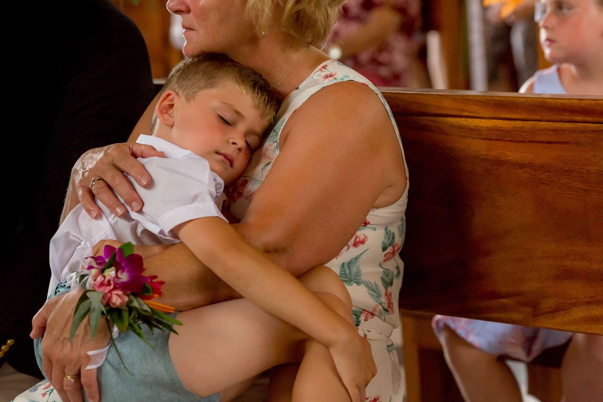 Little boy takes a nap during the church wedding ceremony