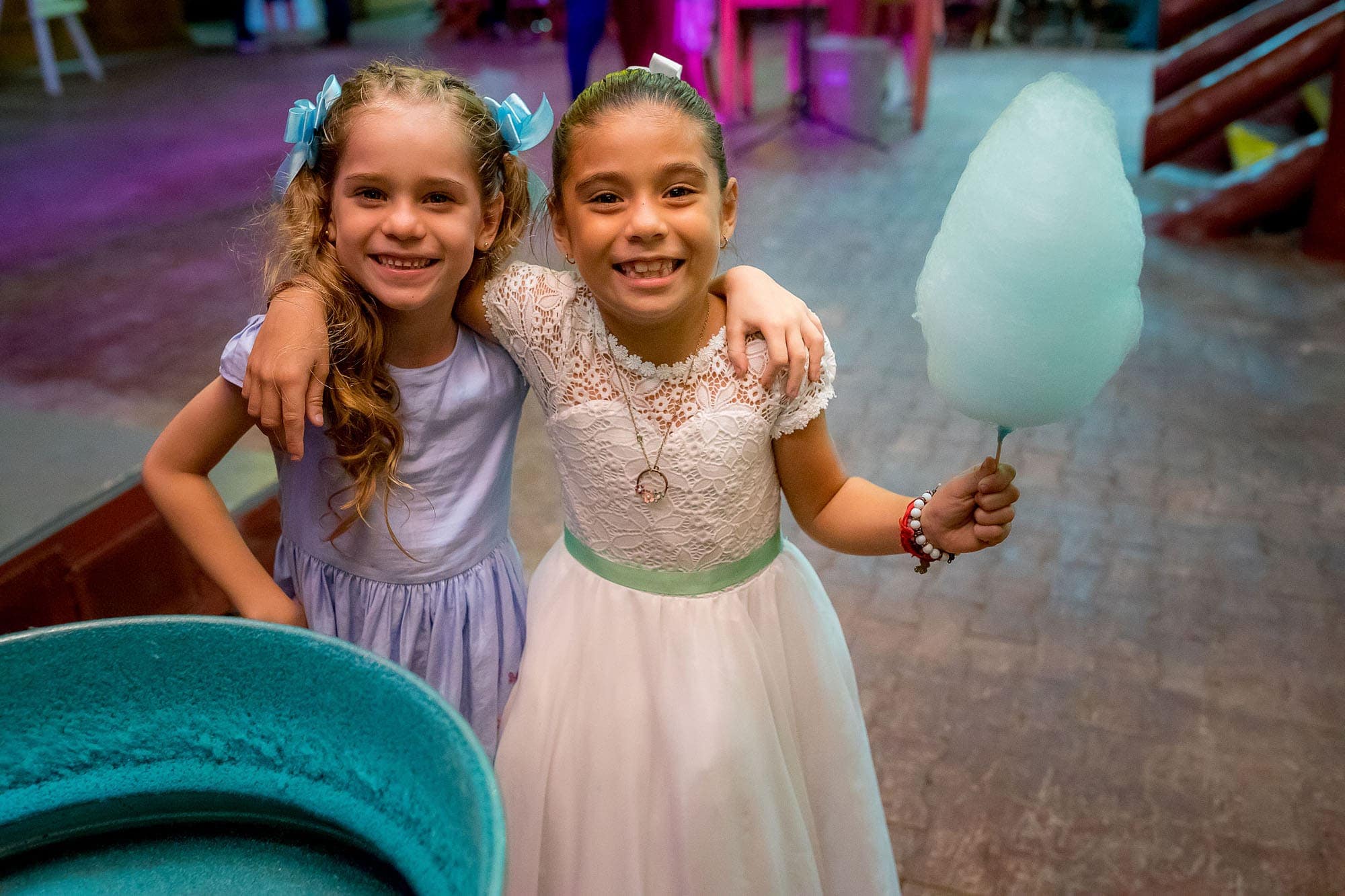 Two little girls enjoying the cotton candy stand