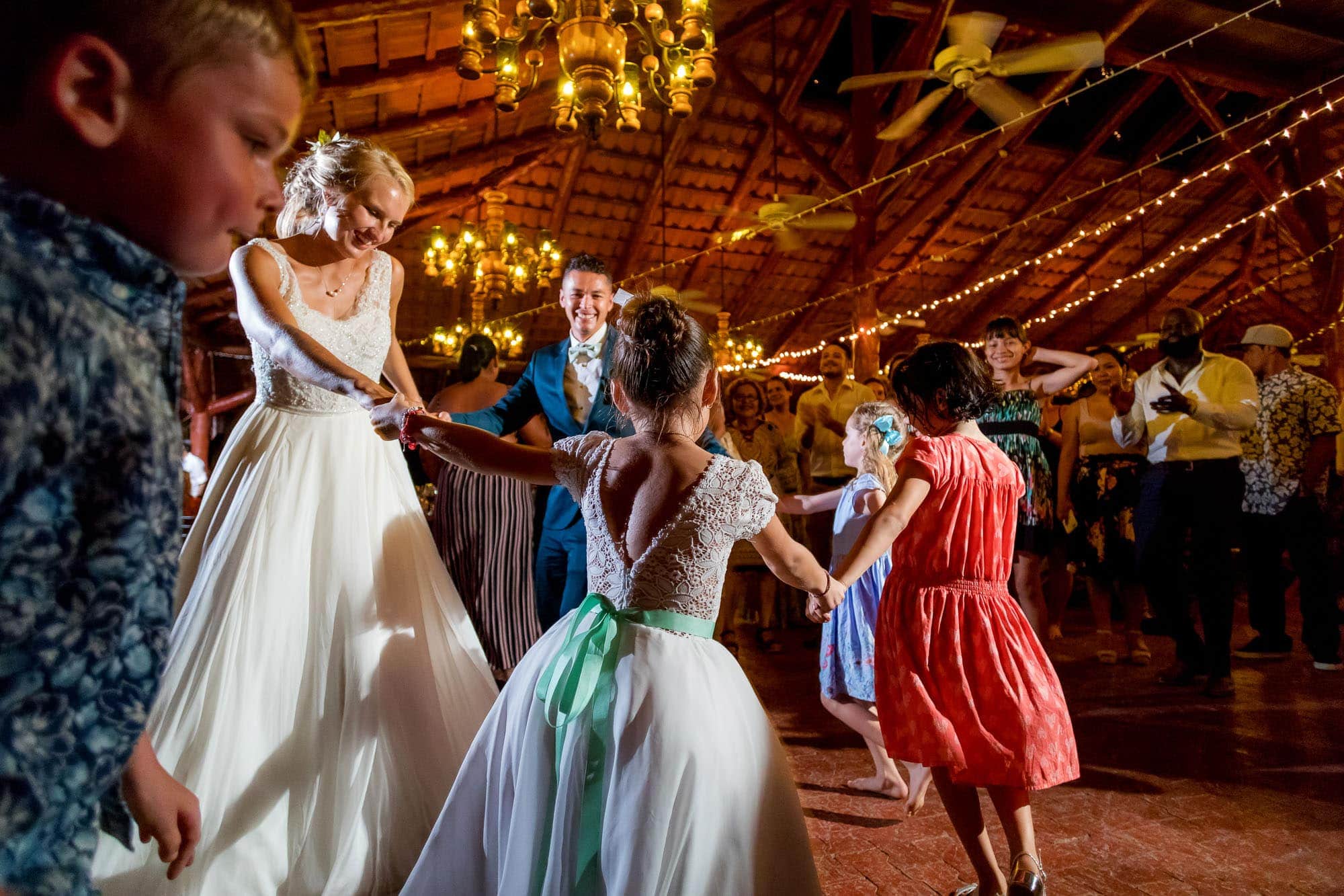 The bride and groom dancing with the kids after the church wedding ceremony