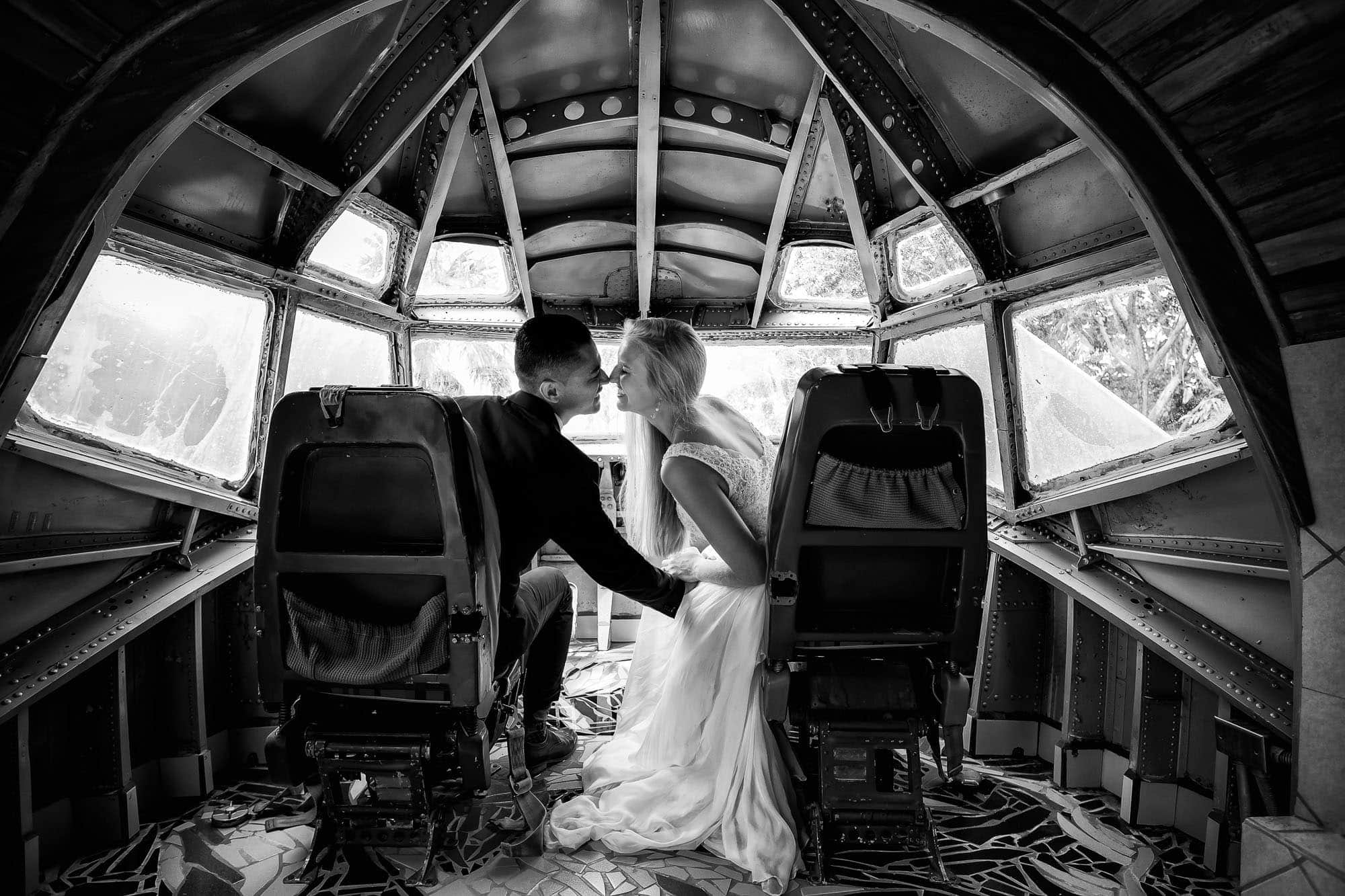 Sharing a kiss in the cockpit of the airplane the day after the church wedding ceremony