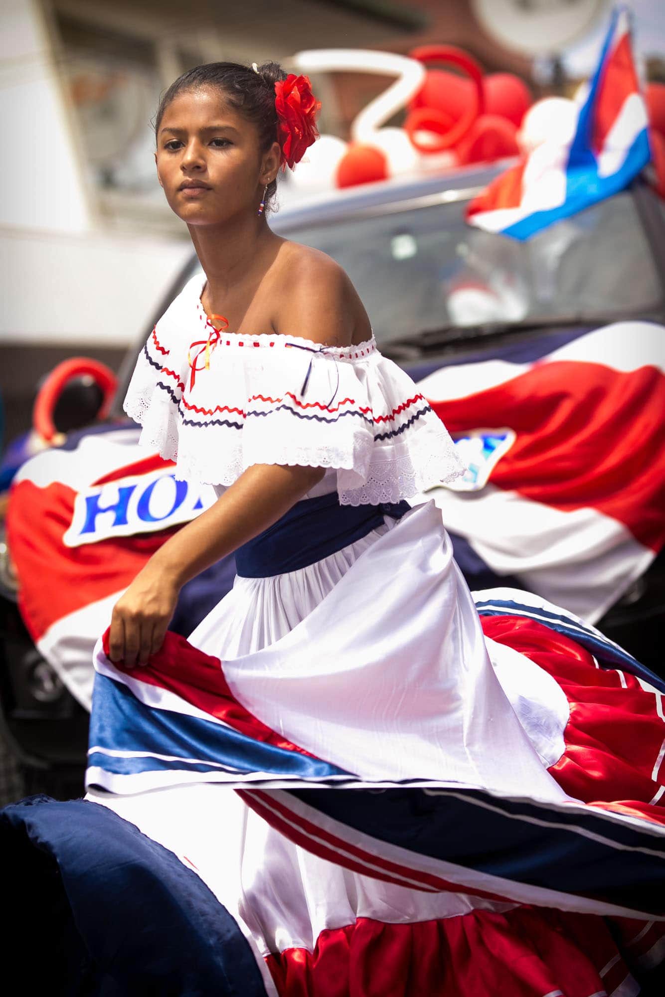 Woman in traditional Costa Rican outfit dancing traditional folk dance during the independence day parade