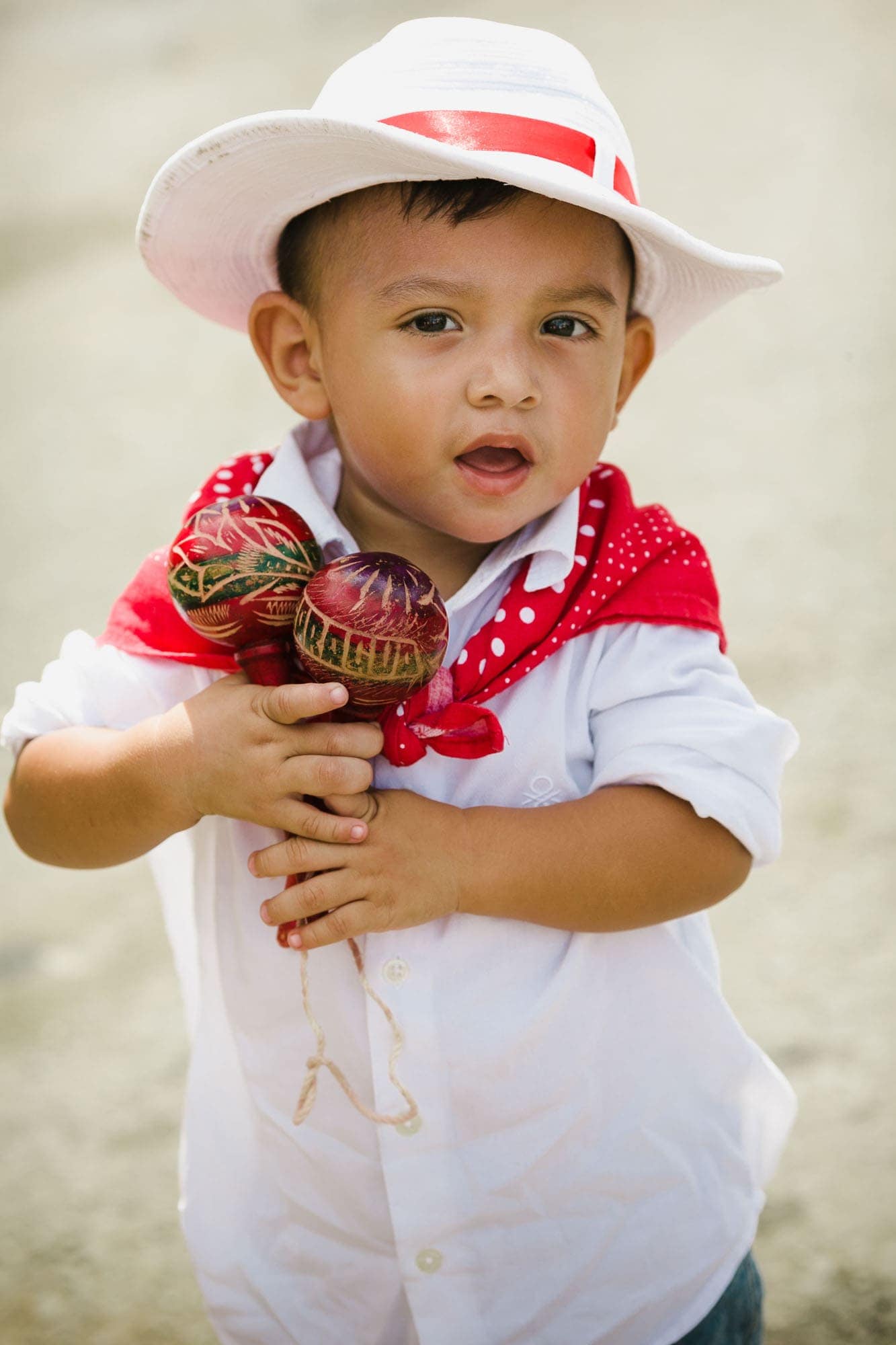 Little boy in campesino outfit (traditional Costa Rican clothing) with maracas