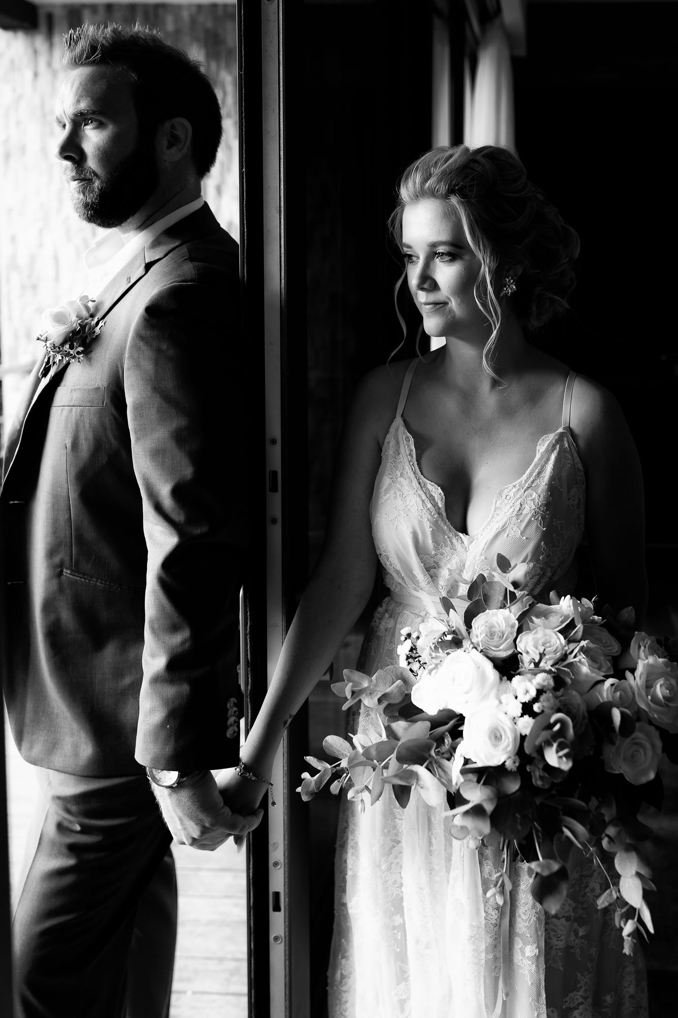 Poignant black and white capture of the bride and groom on either side of a door (they can't see each other yet)