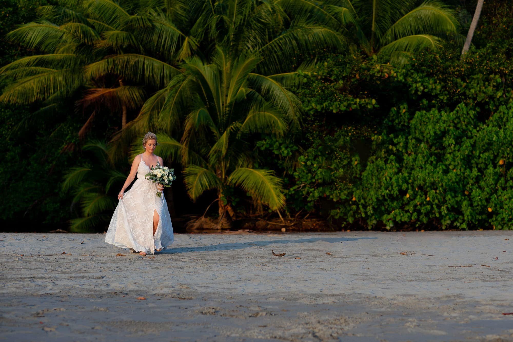 The bride arriving at the ceremony location on the beach
