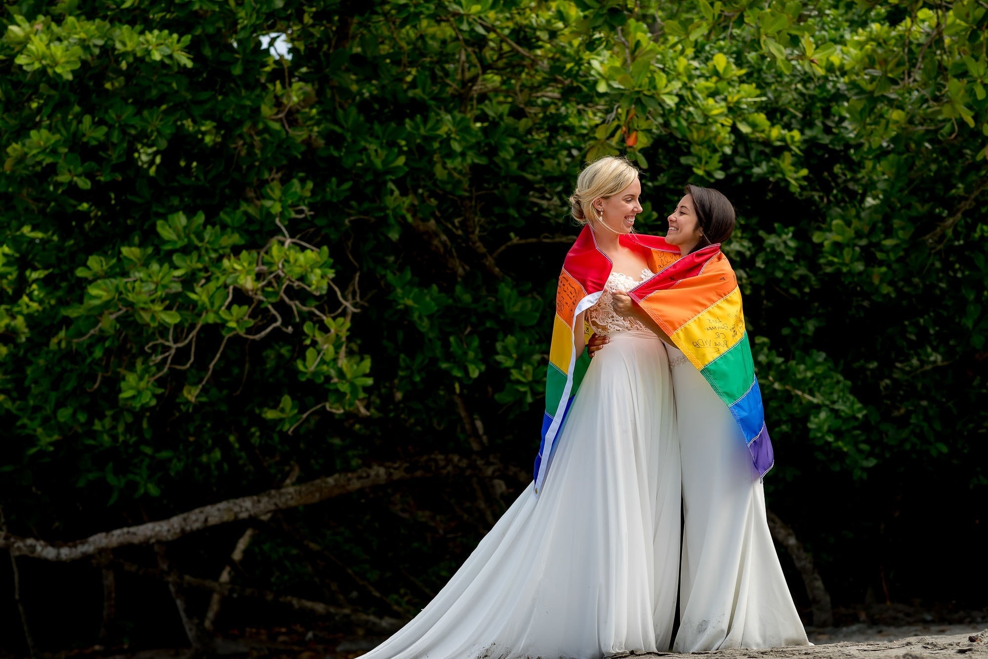 same sex couple with rainbow flag