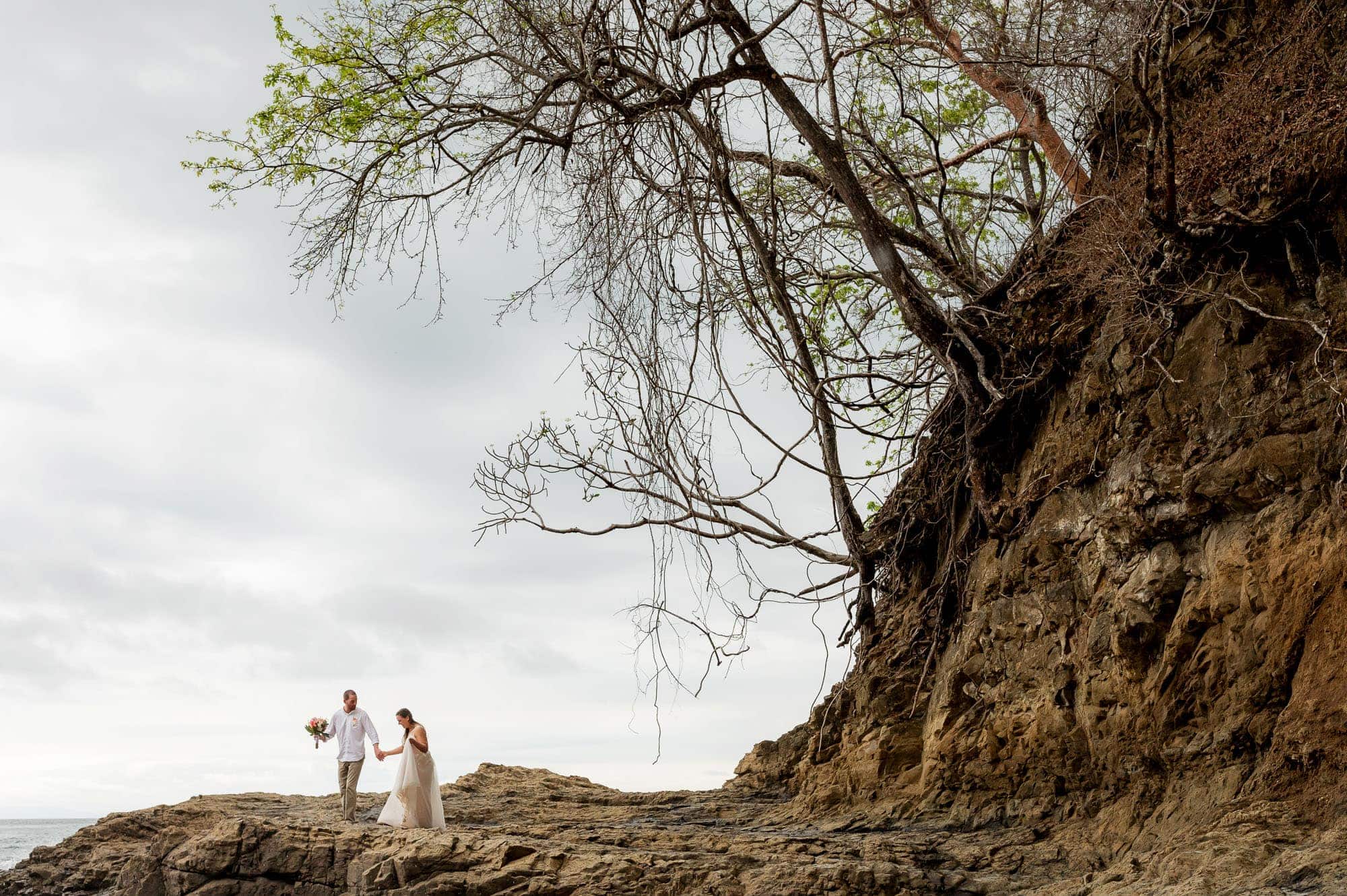 wedding couple walks on rocks