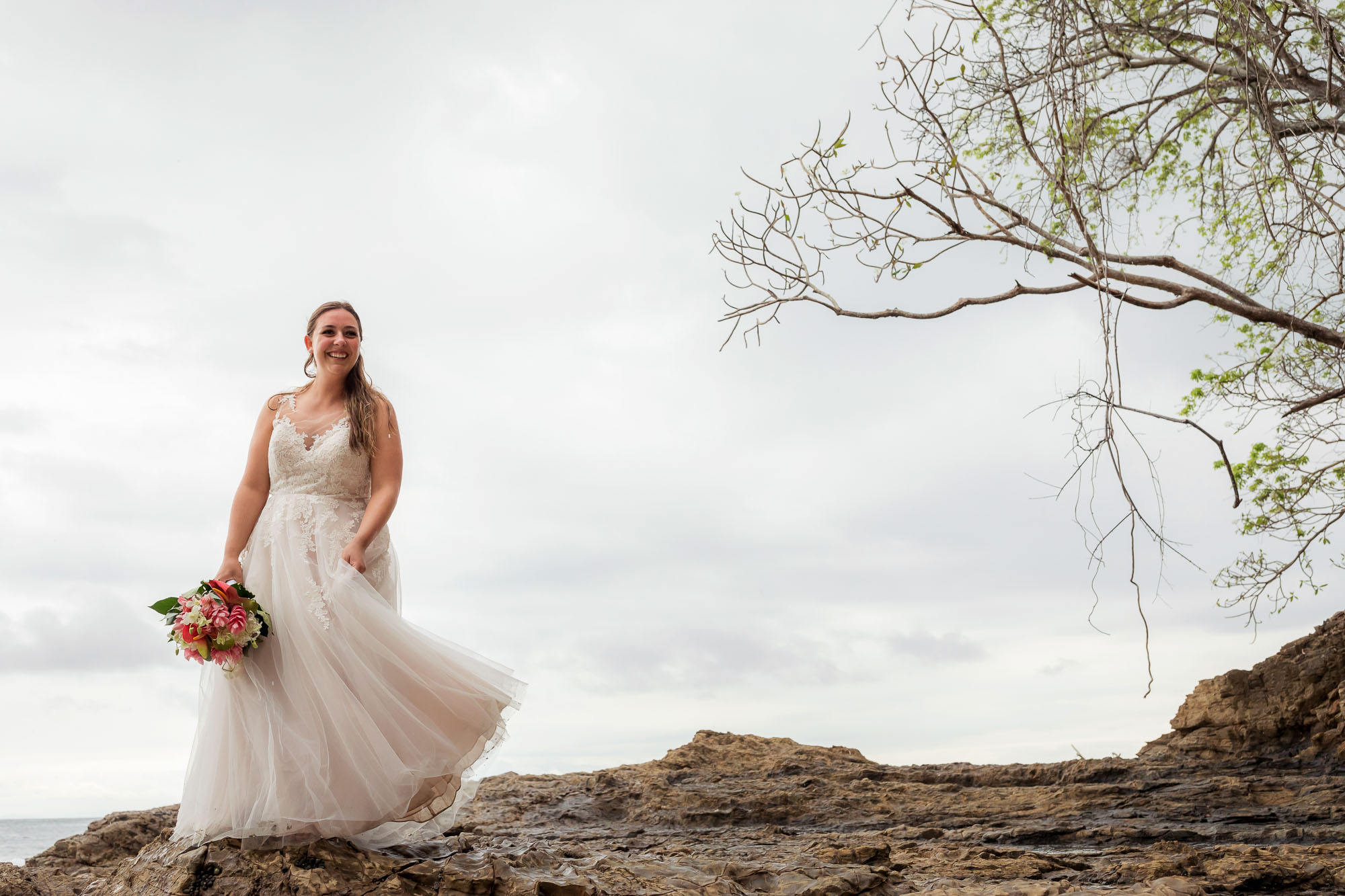 bride on rocks at wedding