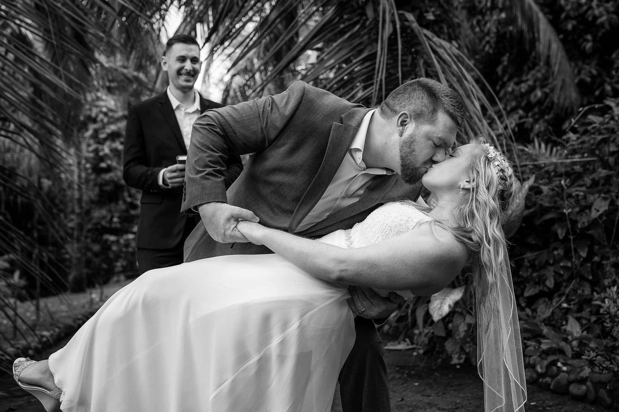 The groom dips the bride for a kiss