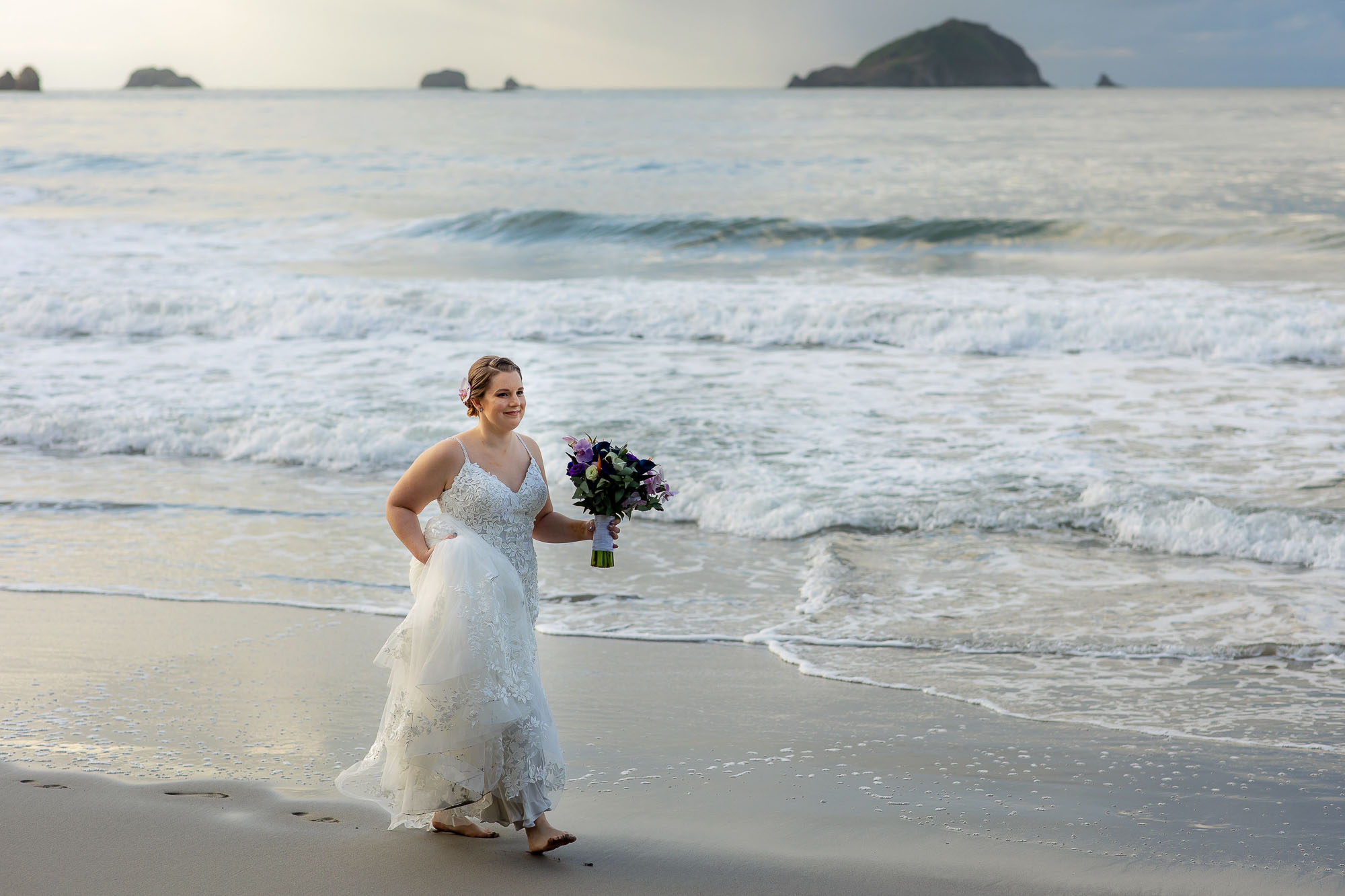 the bride walking along the beach