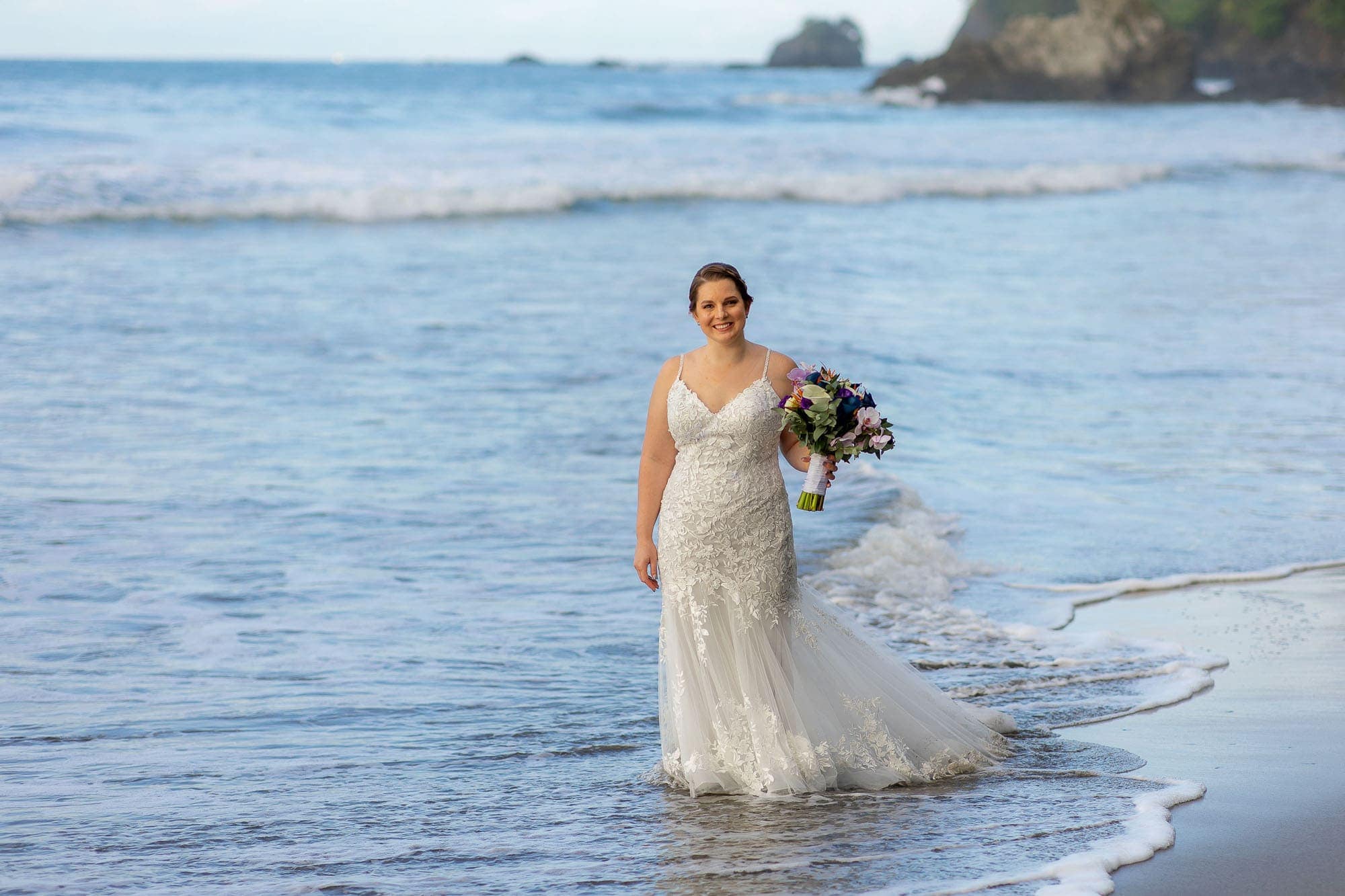 the bride on the beach after her elopement at Hotel Parador in Costa Rica