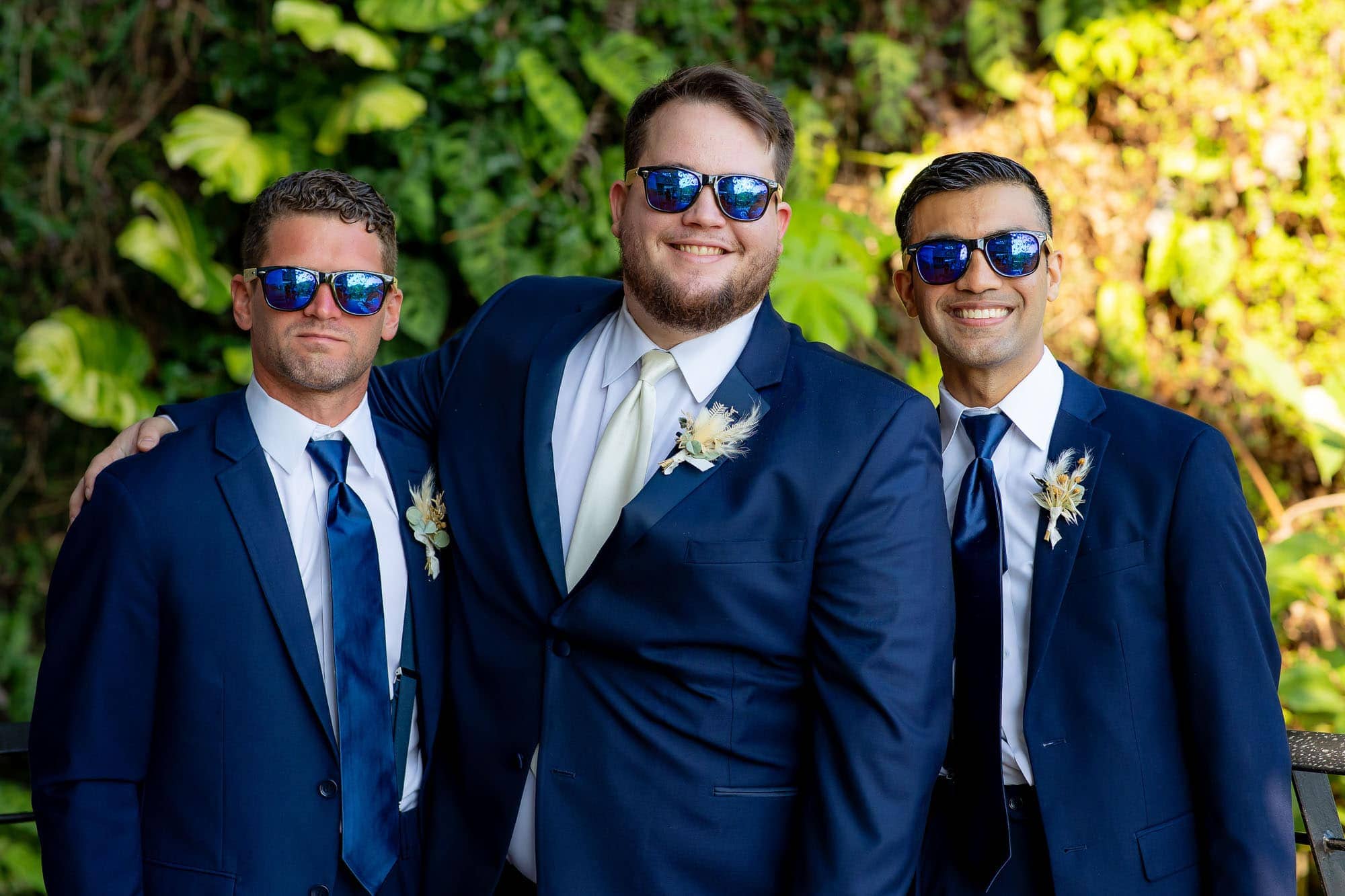 the groom and his groomsmen with dark blue sunglasses