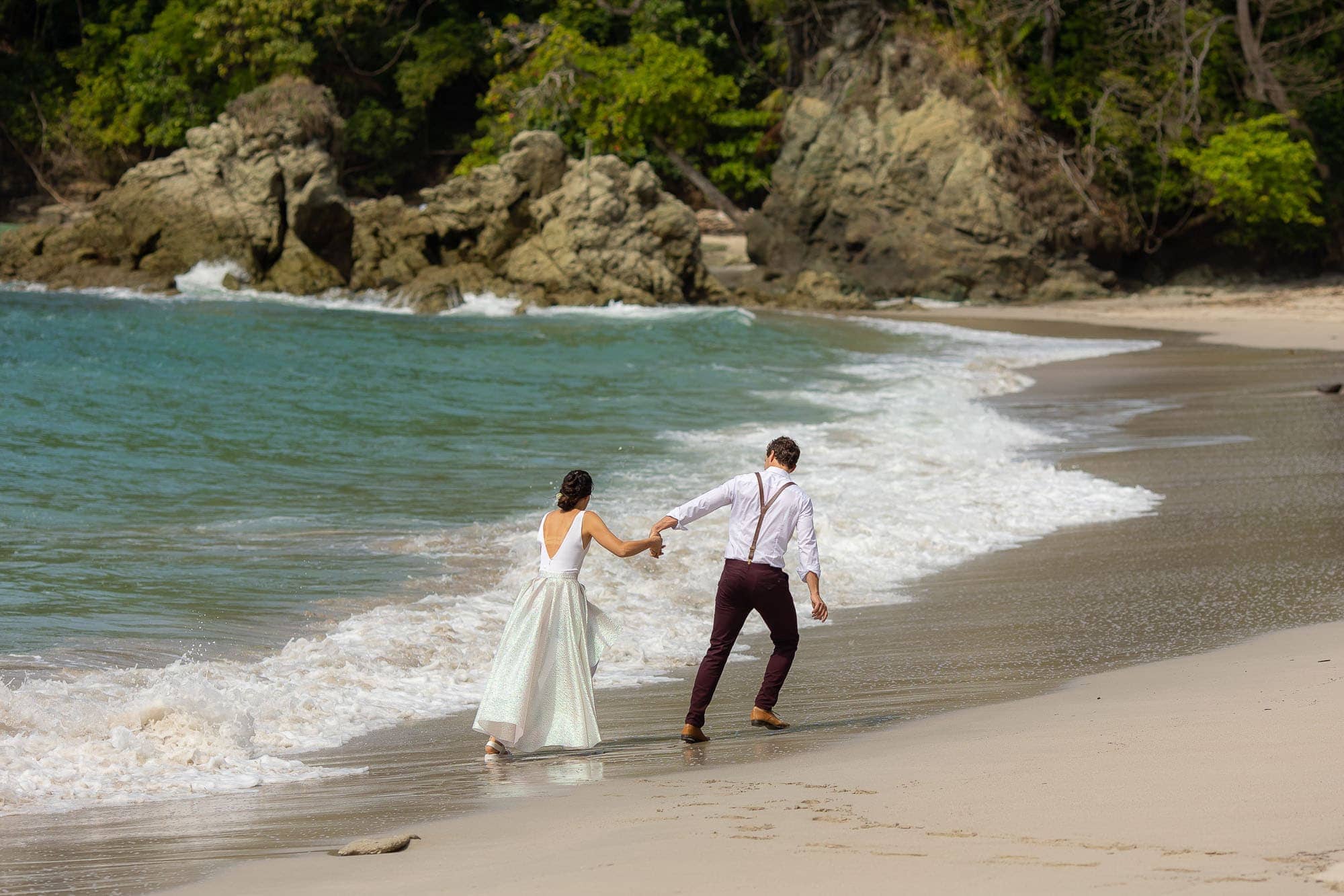 the bride and groom on manuel antonio beach