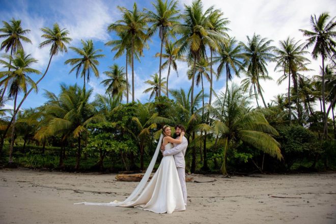 The bride and groom on the beach during their costa rica wedding getaway