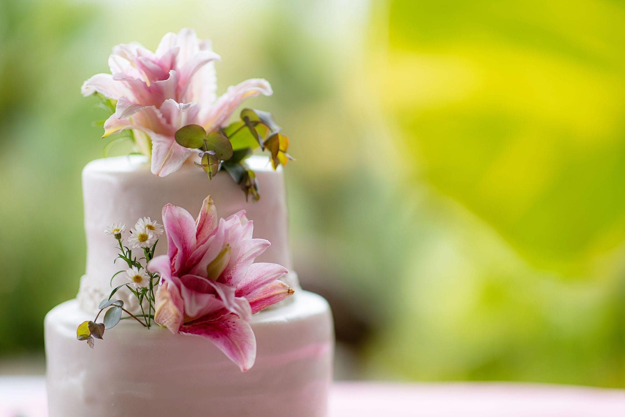 close up of the wedding cake with pink lilies