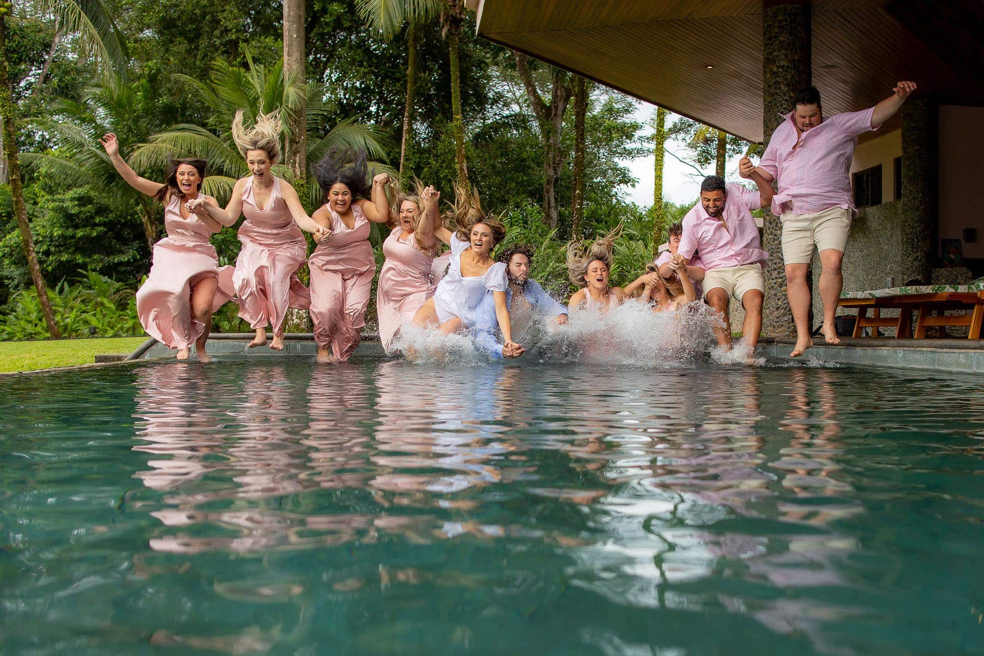 The whole wedding party jumps in the pool!