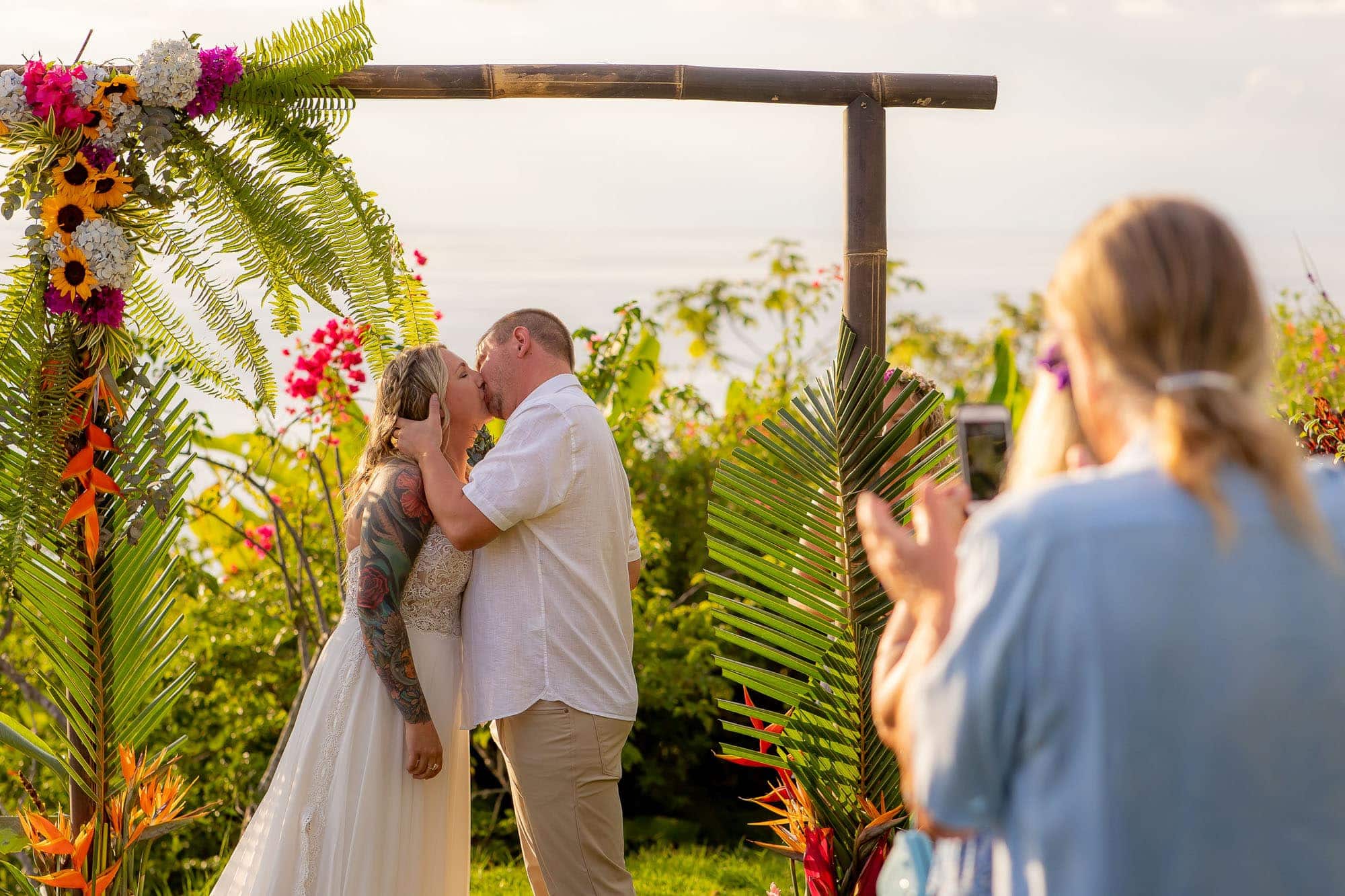 Bride and groom share a kiss at their picture-perfect Dominical, Costa Rica beach wedding