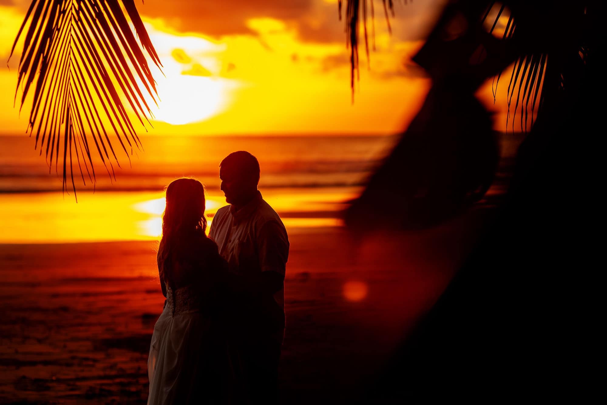 Bride and groom silhouetted with the epic sunset