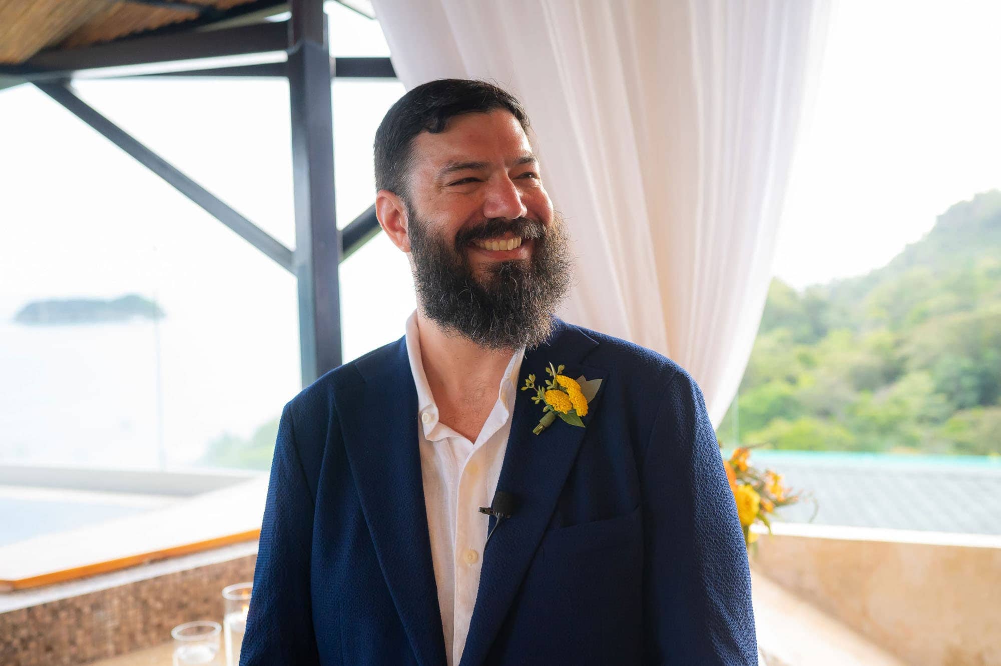 The groom smiling at his bride