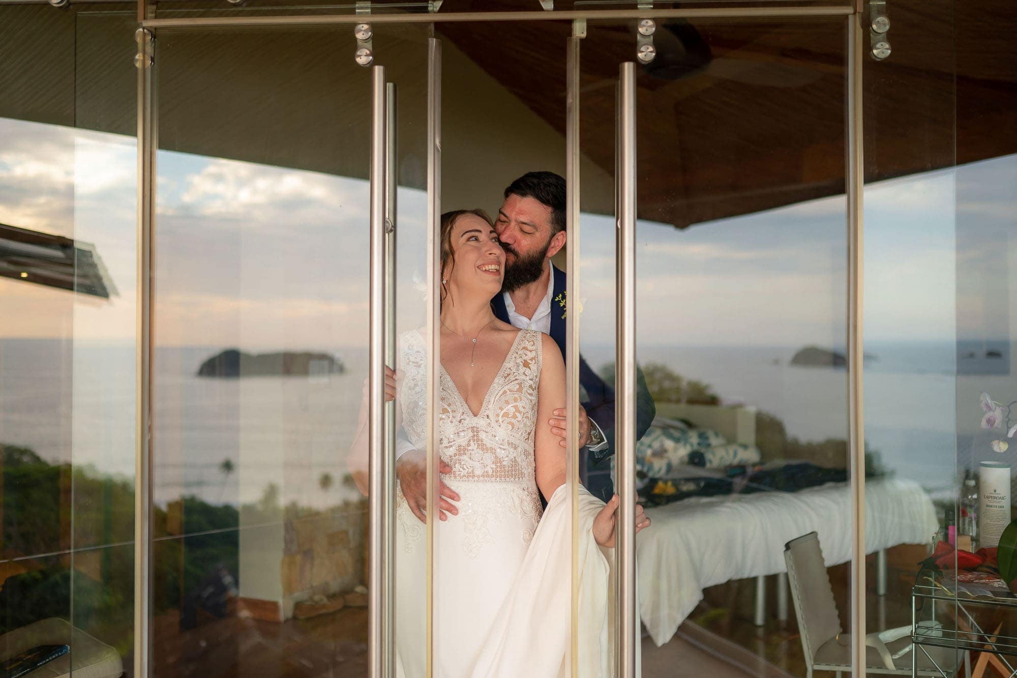 Bride and groom peeking out of their room at Punto de Vista