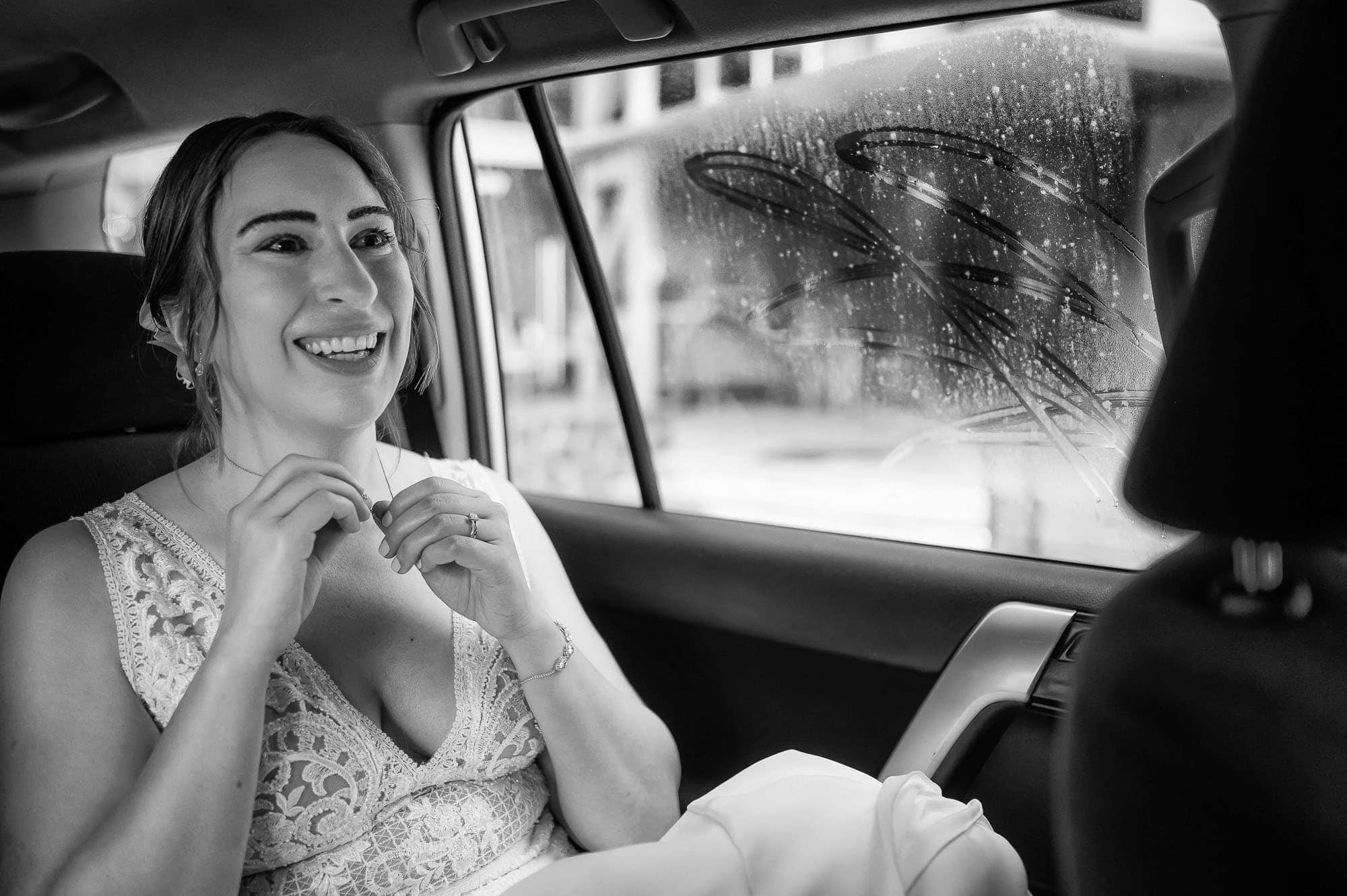 Excited bride in a car on her way to the beach