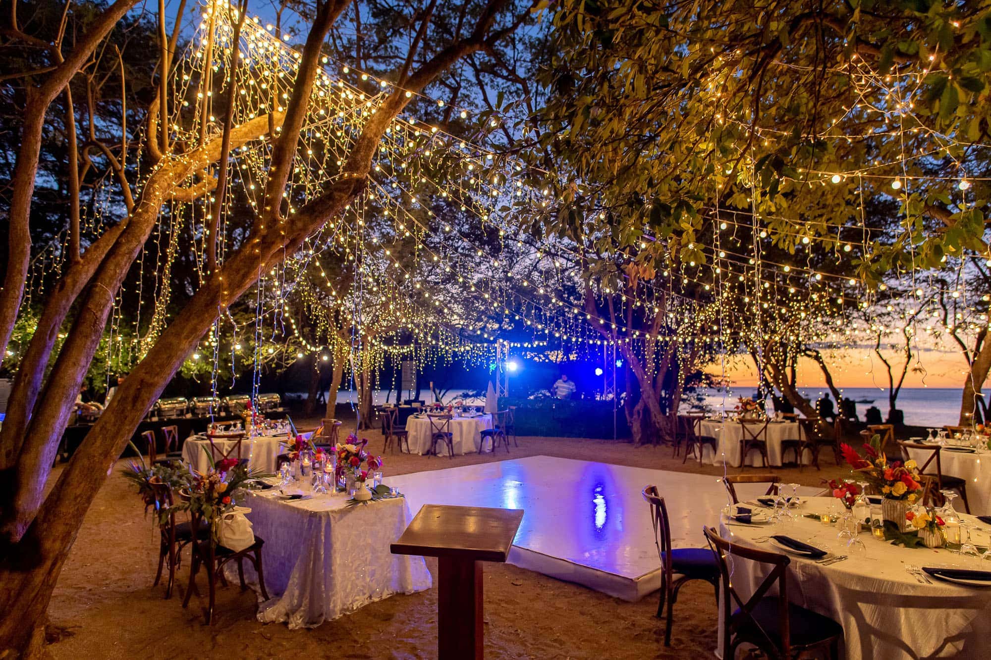 reception space on the beach lit up with fairy lights