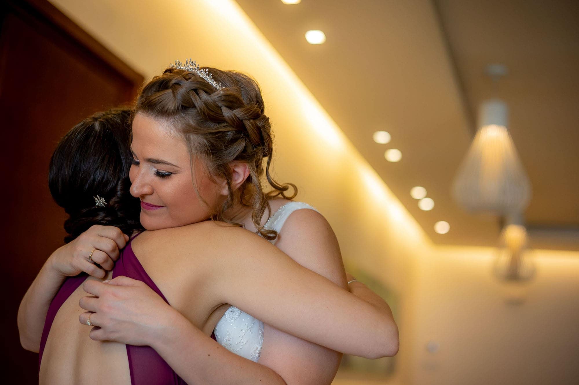 Bride hugging a bridesmaid