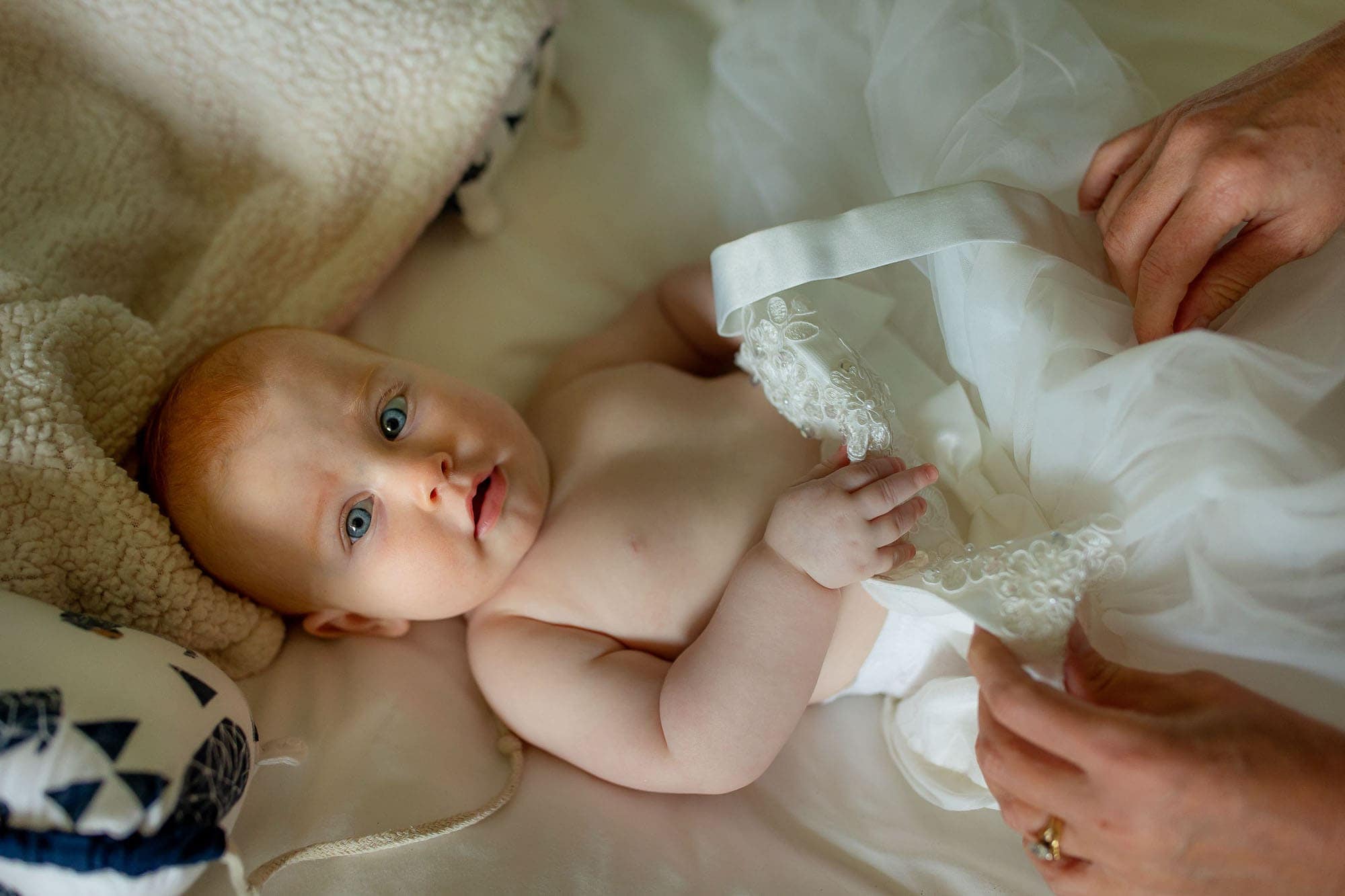 Baby getting dressed for her parents' wedding