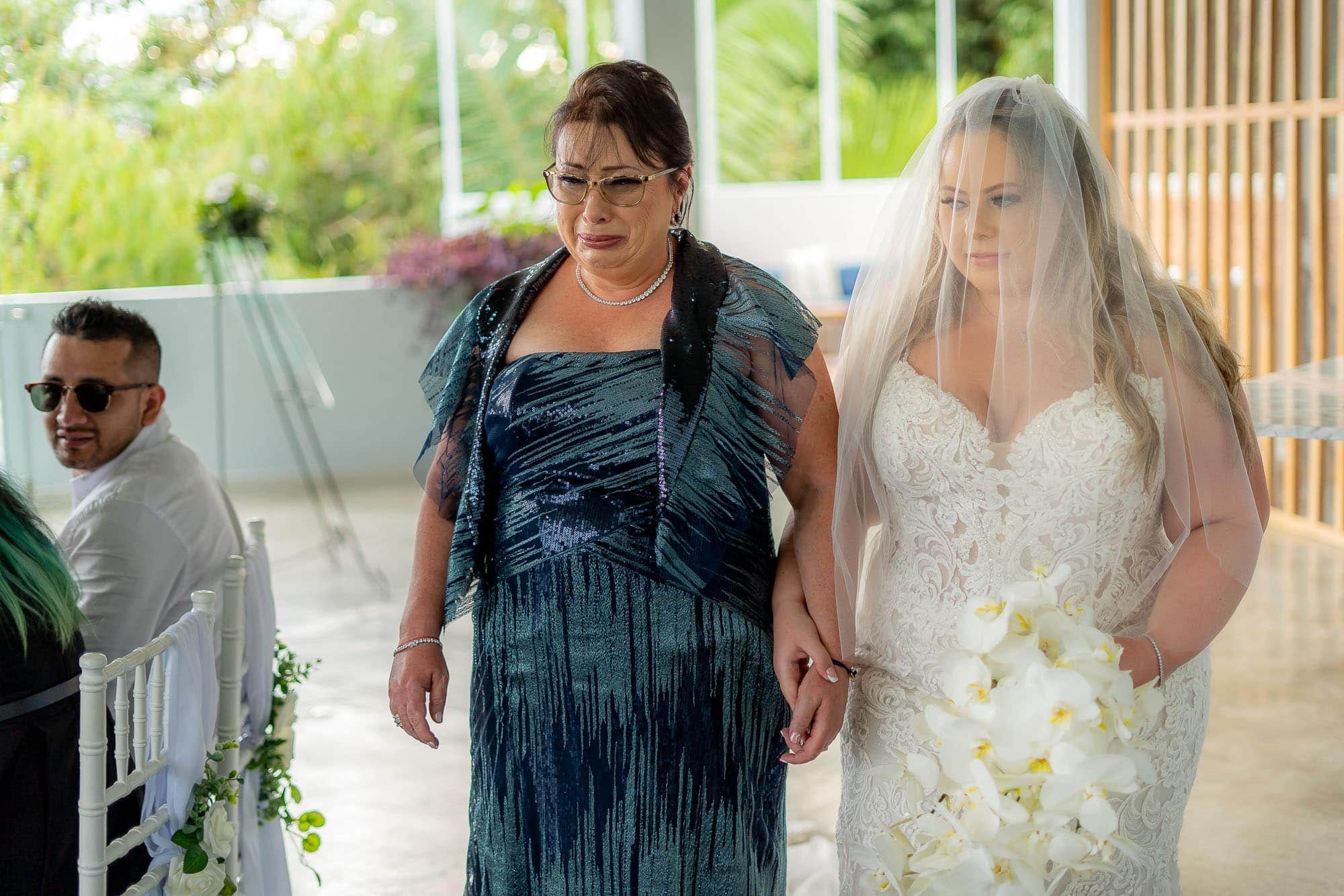 Mom cries as she walks the bride down the aisle