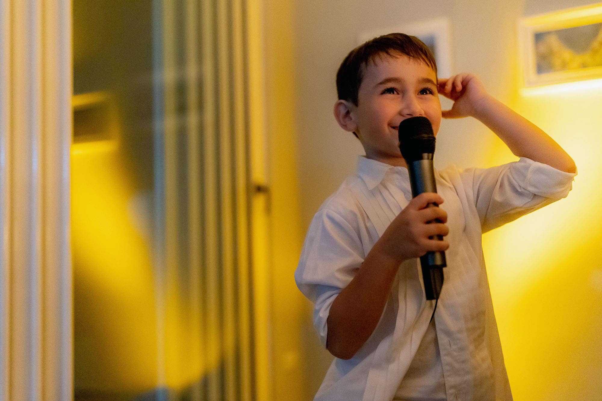 Little boy makes a toast with the mic
