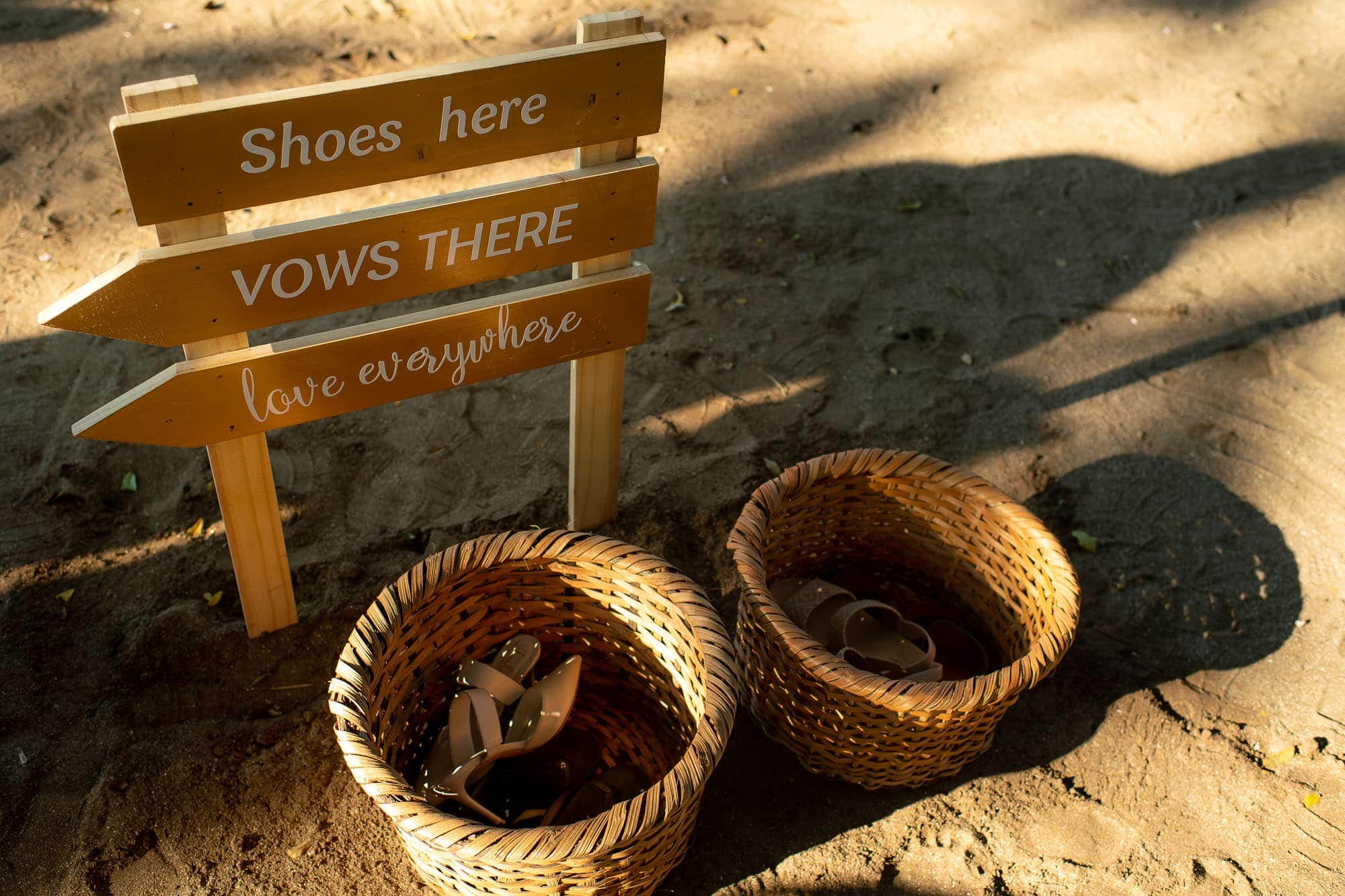 baskets for shoes and a sign that says "shoes here, vows there, love everywhere"