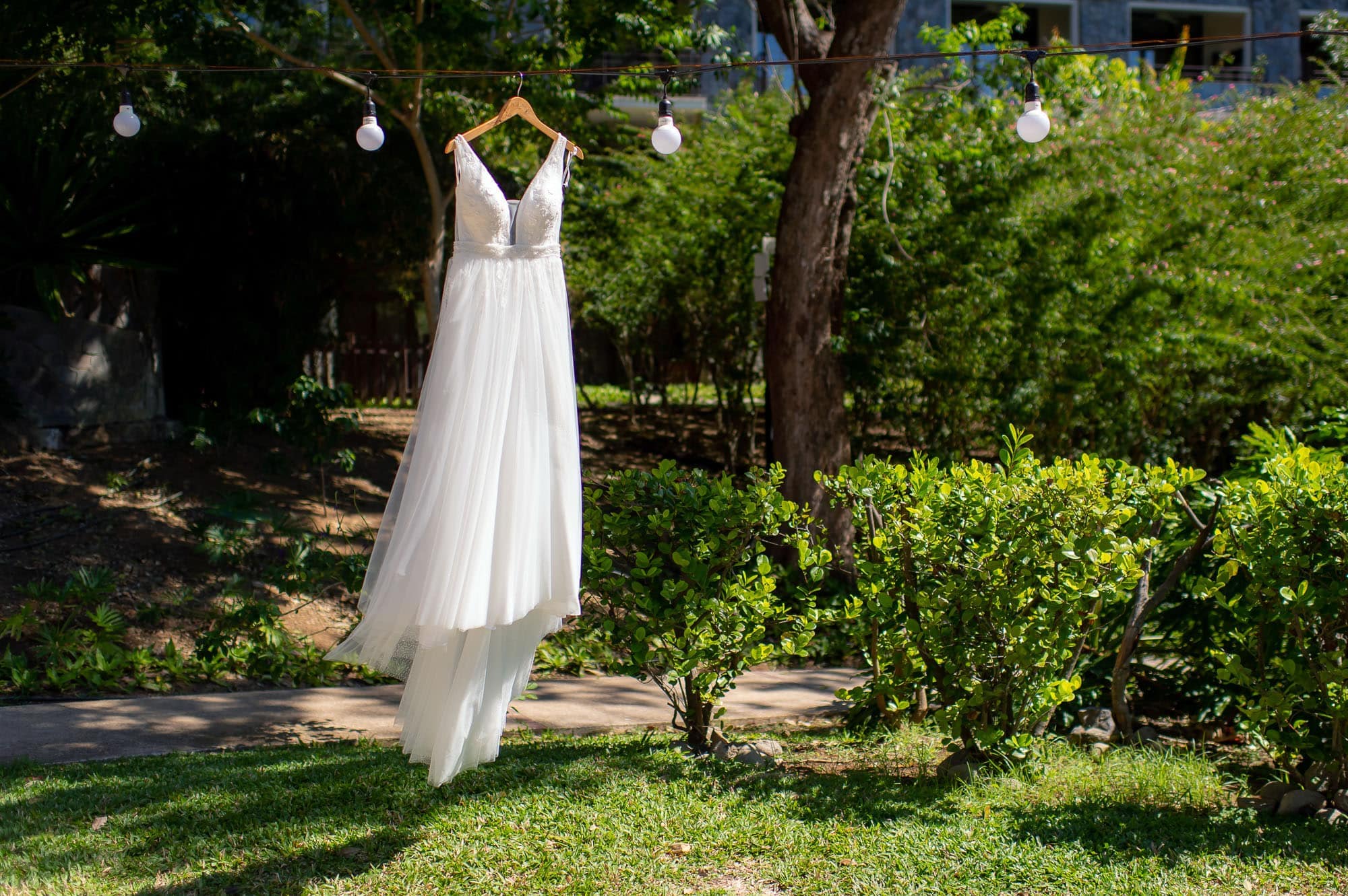The bride's dress hanging at the wedding reception site at dreams las mareas resort
