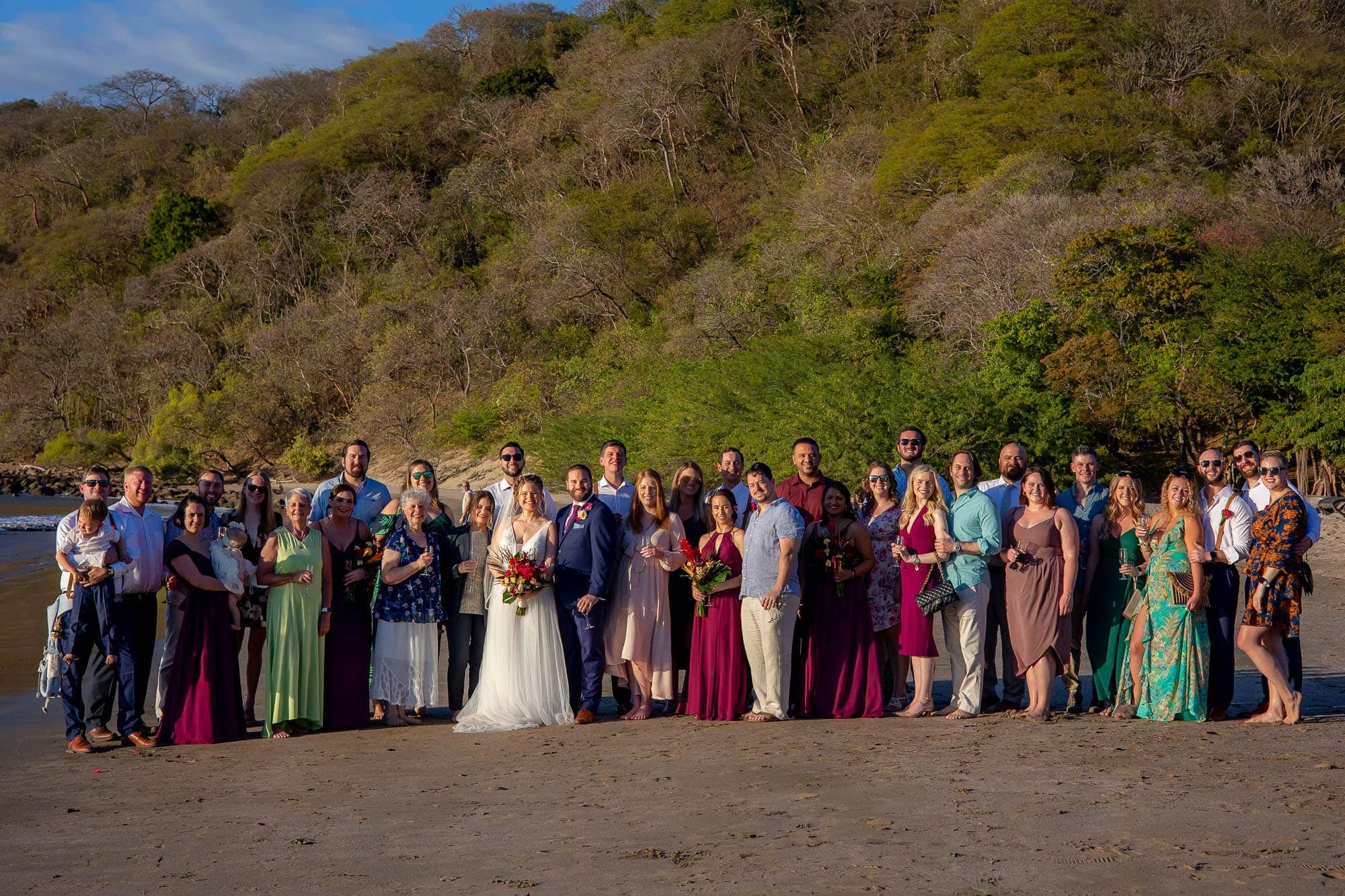 Group shot of the bridal party and guests at dreams las mareas all inclusive resort