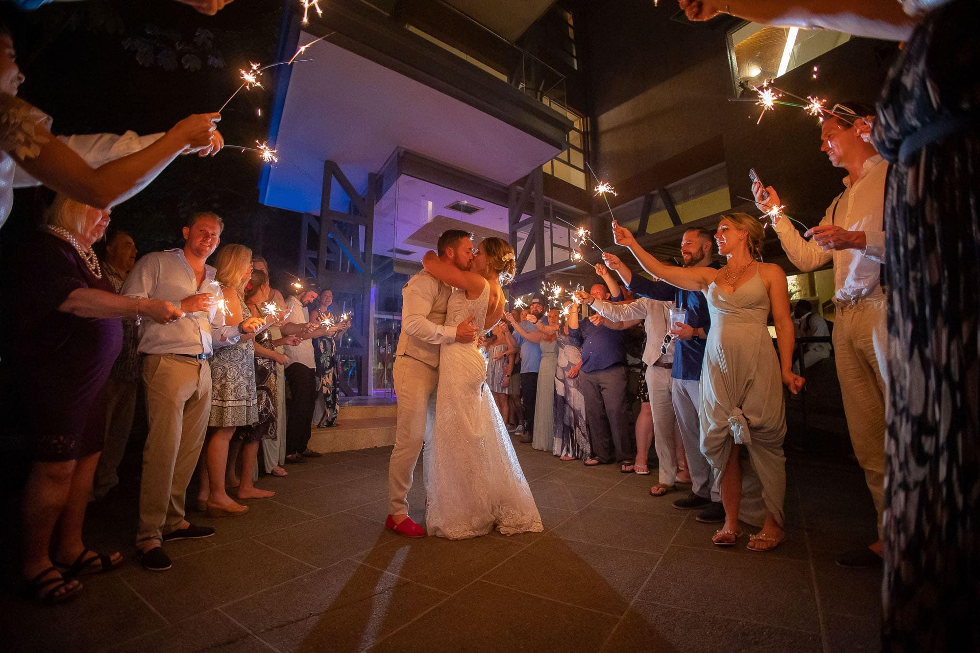 Bride and groom kiss during their sparkler send off!