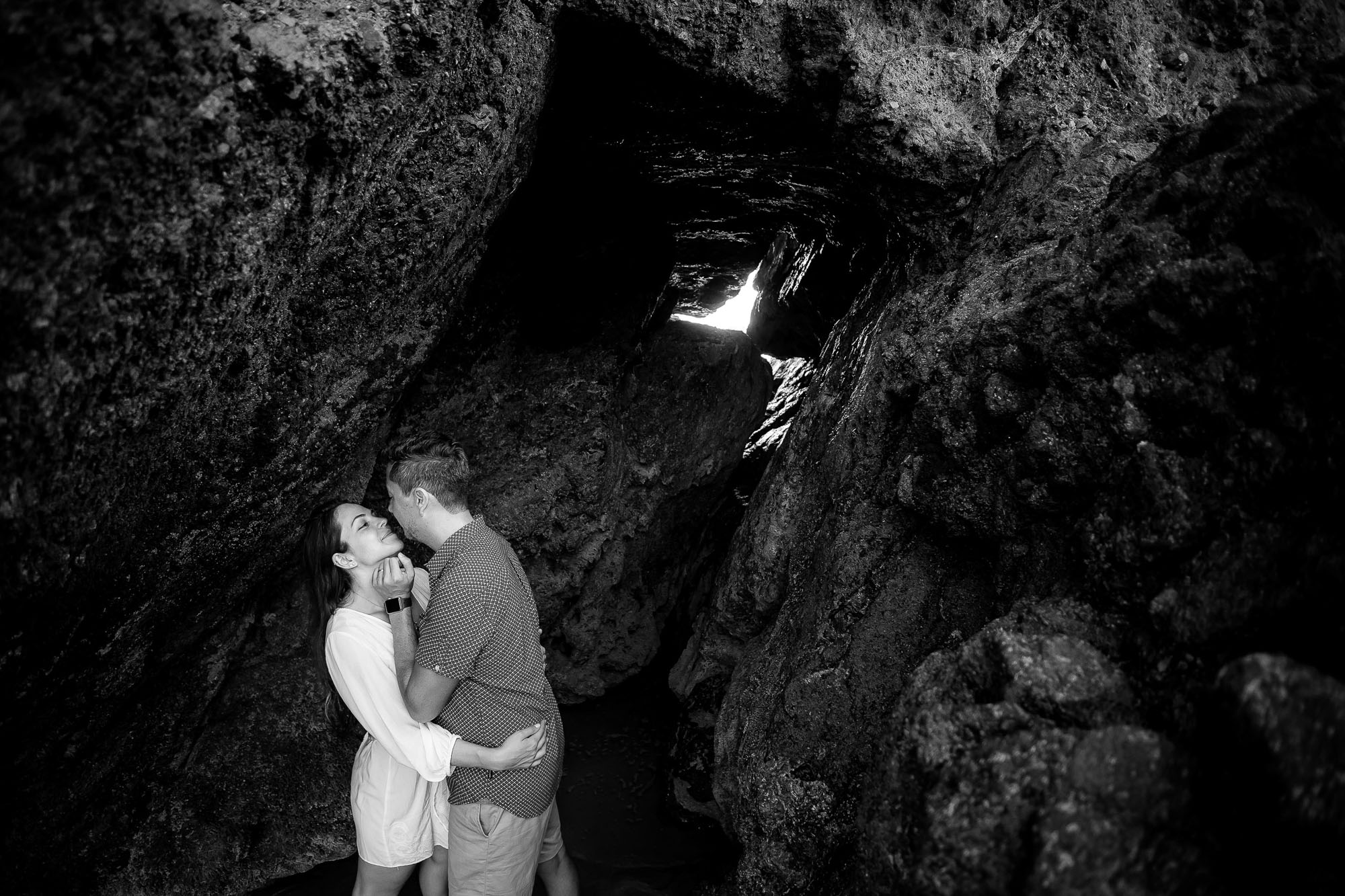 Bride and groom snuggling in a rock formation