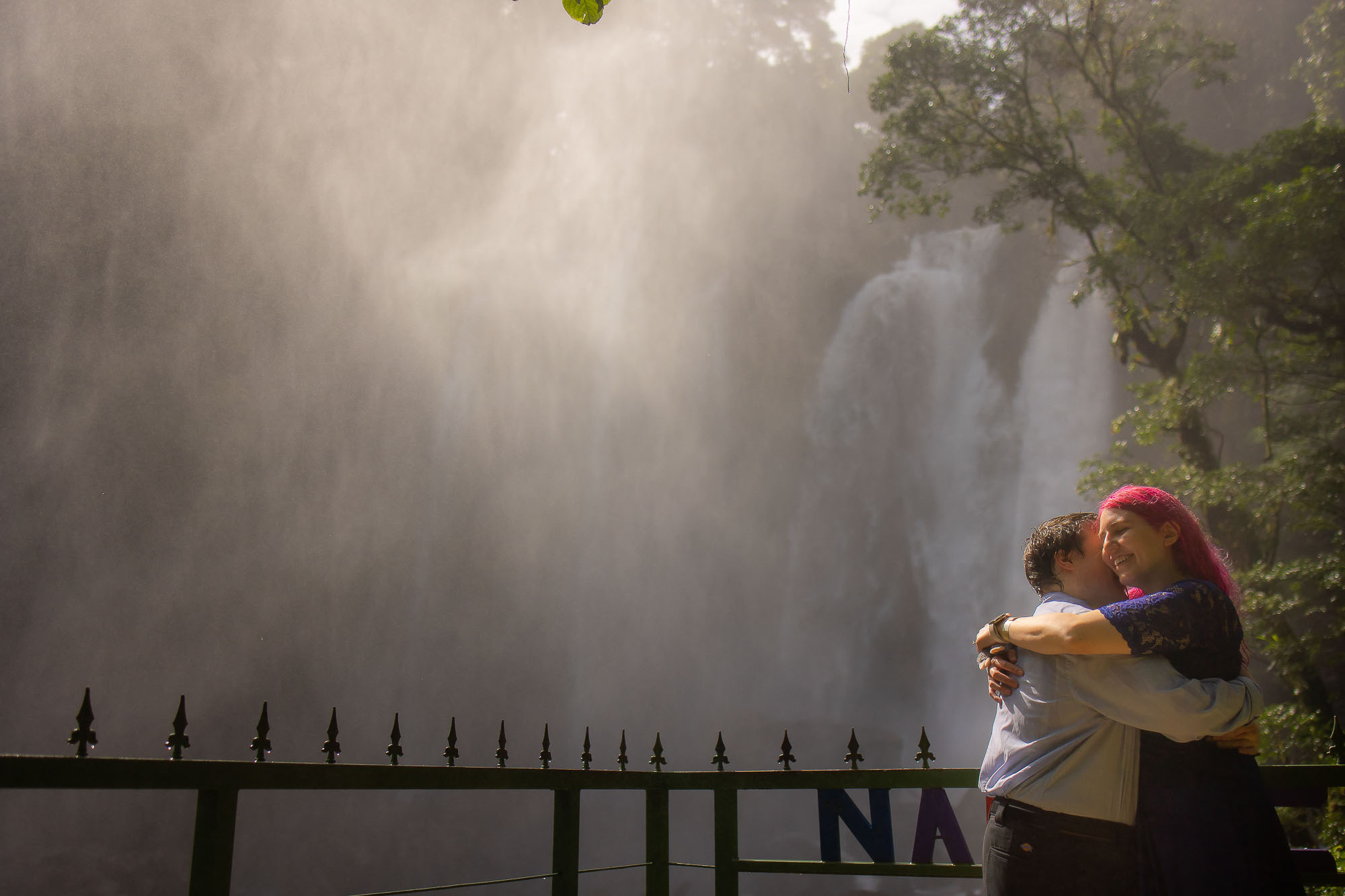 couple hug in front of falls