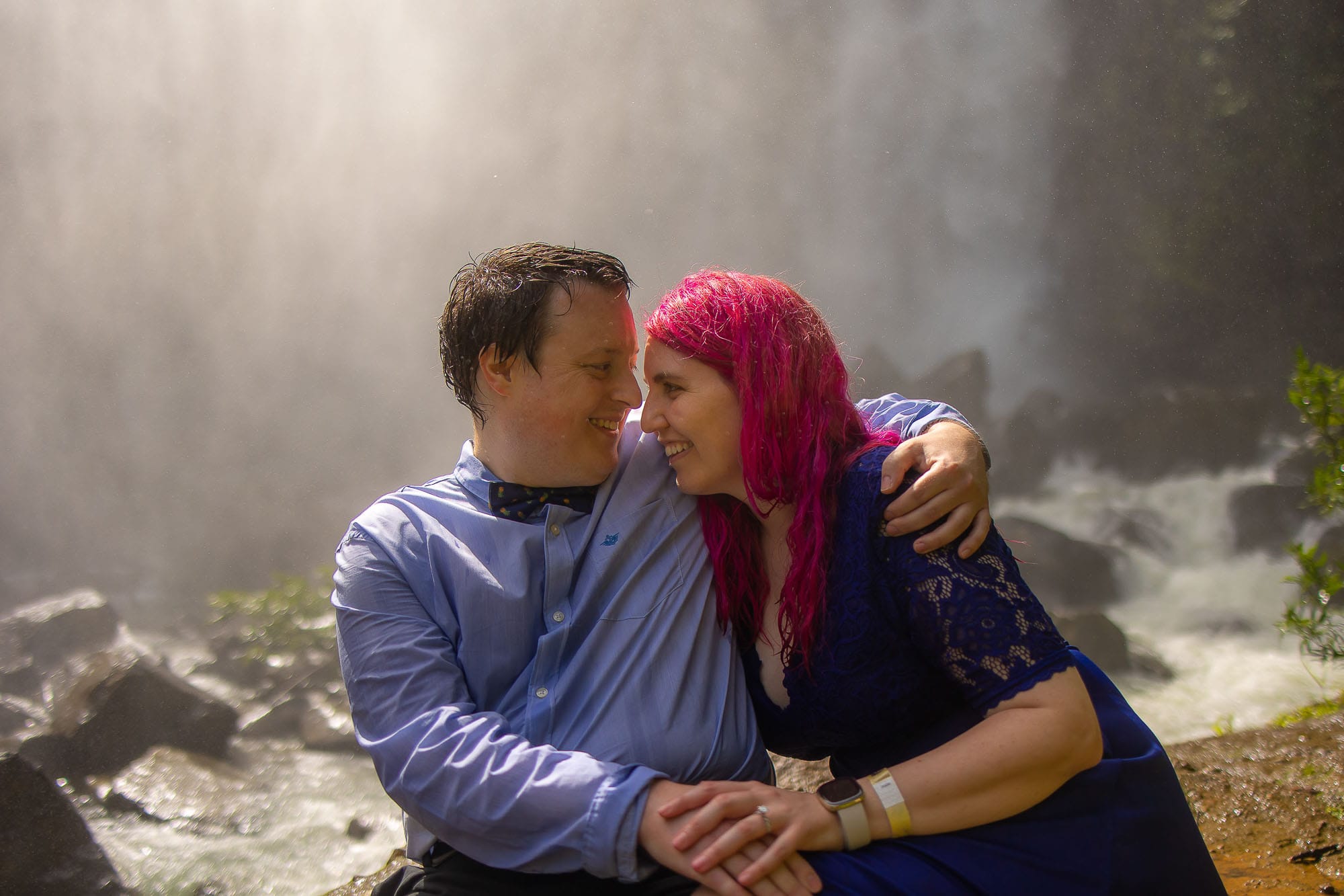 couple sitting at waterfall
