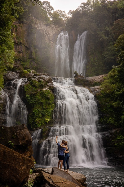 couple facing waterfall