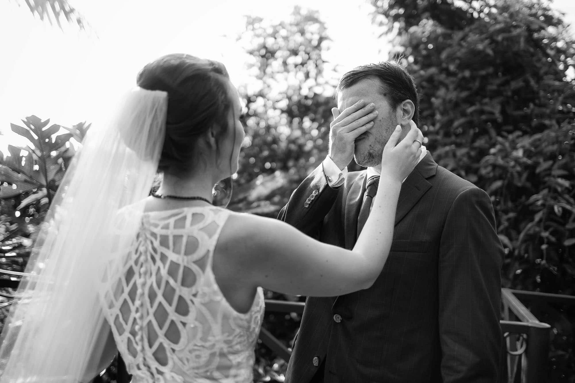 Groom covers his eyes as he prepares to see his bride for the first time