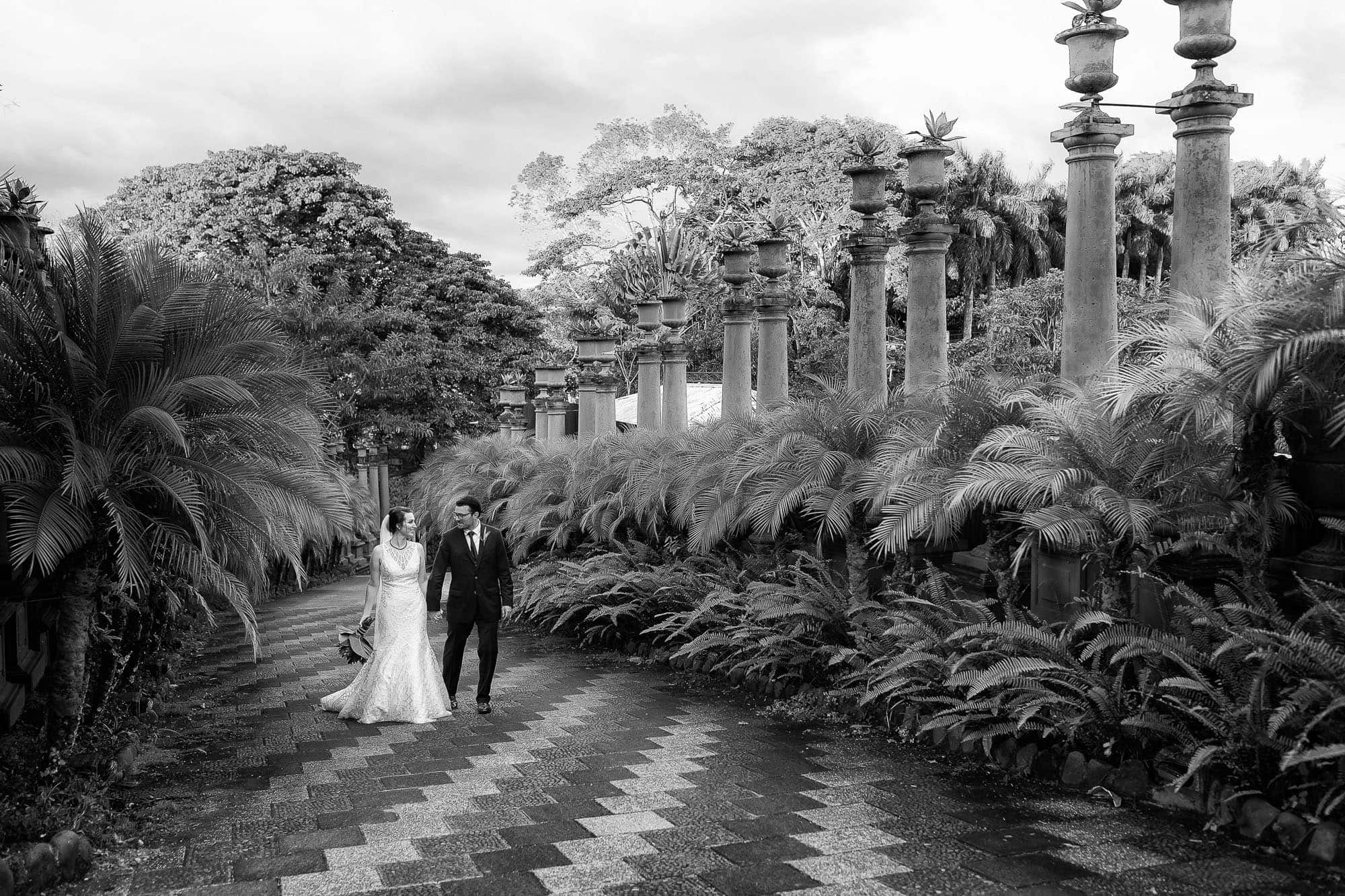 bride and groom stroll through the grounds at Zephyr Palace