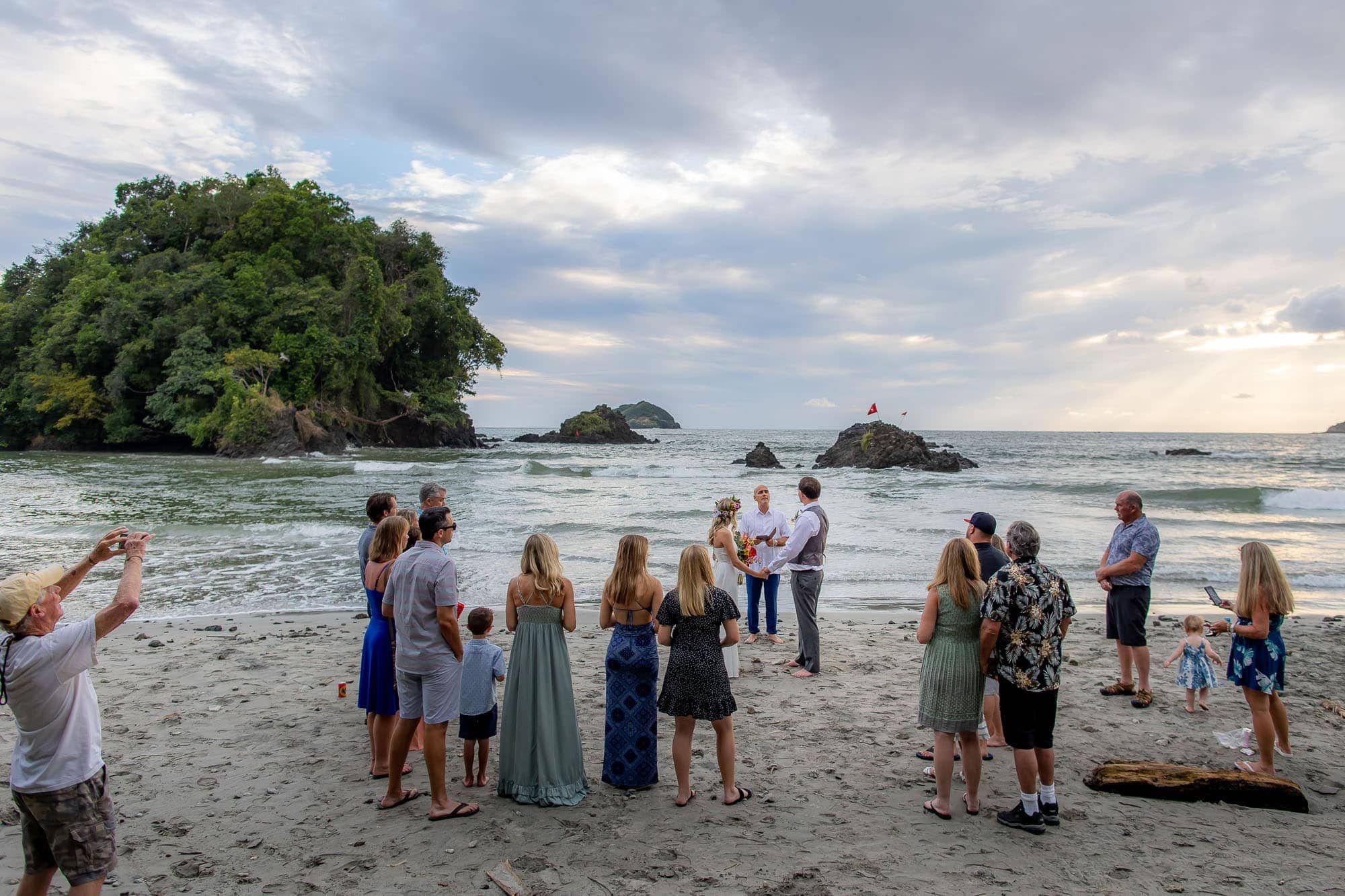wedding ceremony on beach photographed by second photographer