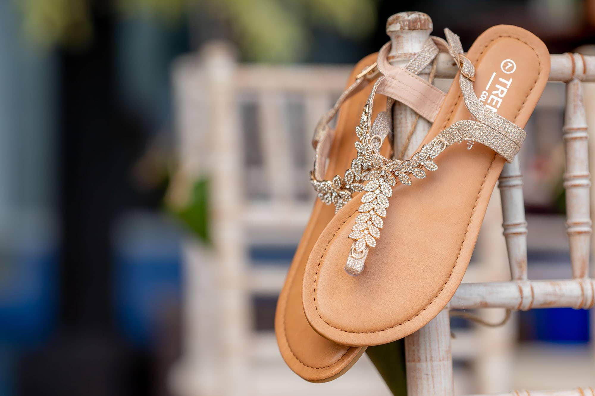 wedding sandals hanging over the back of a chair